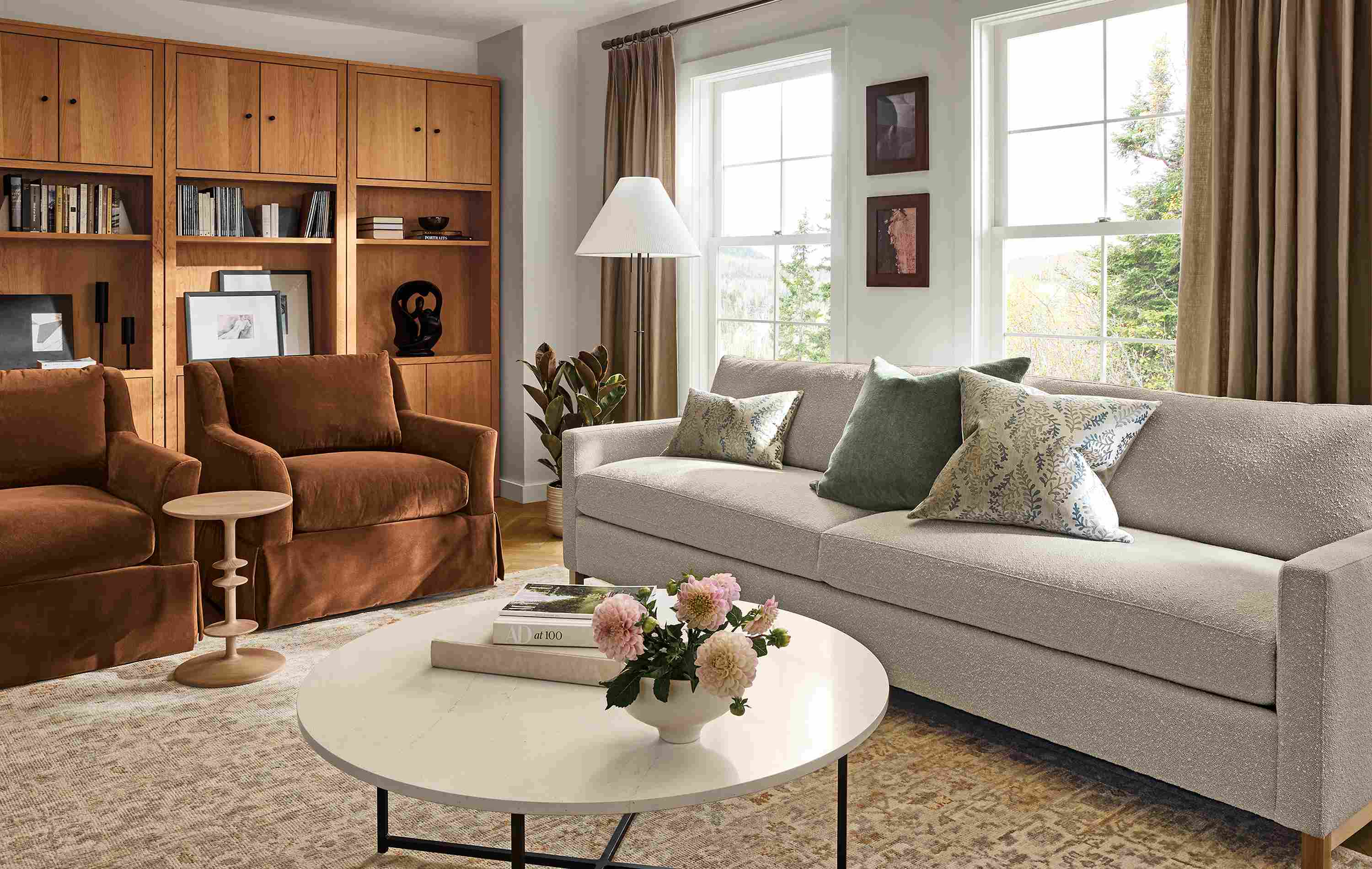 Living room with Stevens 101-wide sofa in Declan Natural, 2 sybil skirted chairs in redding nutmeg and Rosalie rug.