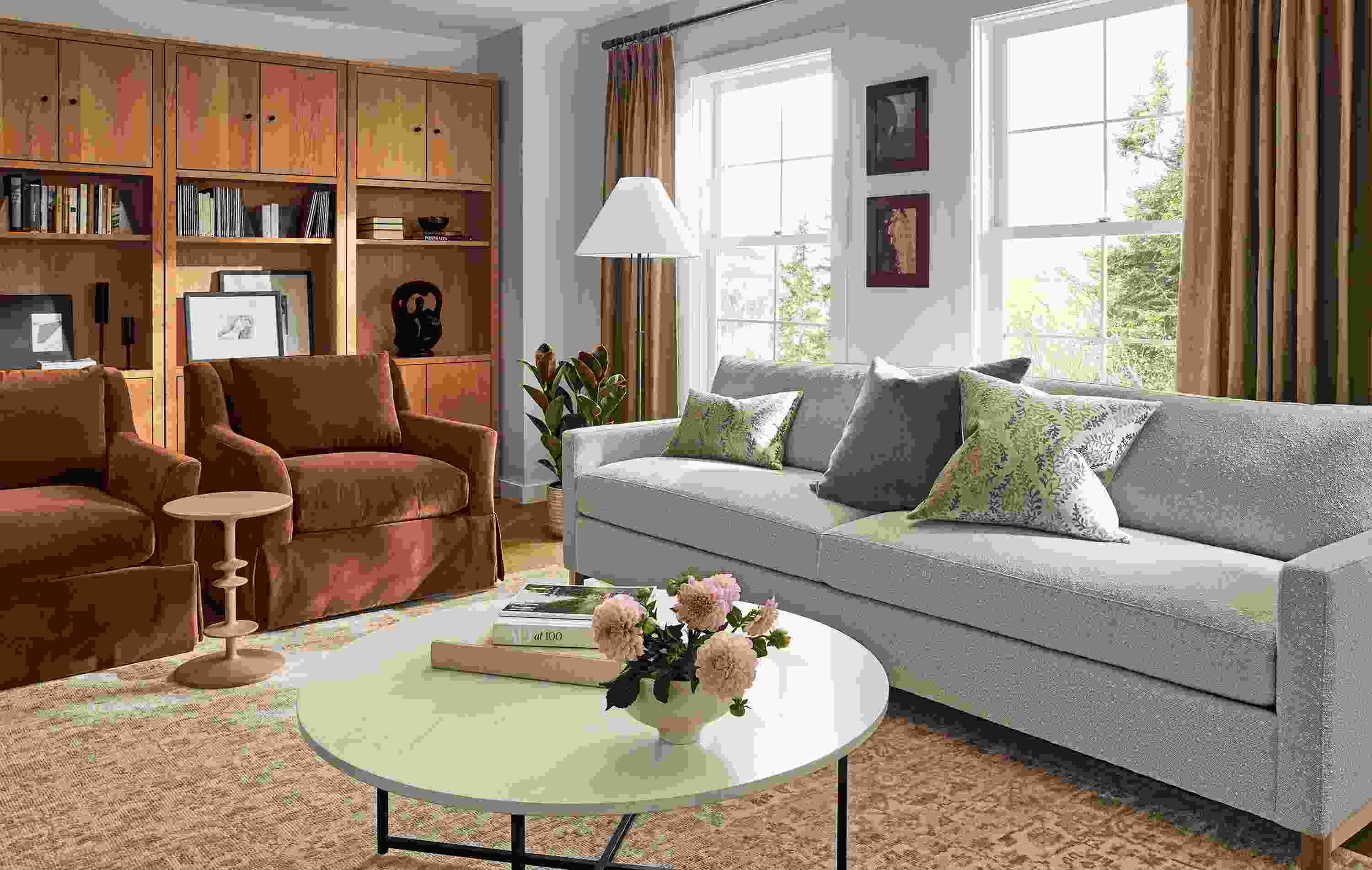 Living room with Stevens 101-wide sofa in Declan Natural, 2 sybil skirted chairs in redding nutmeg and Rosalie rug.