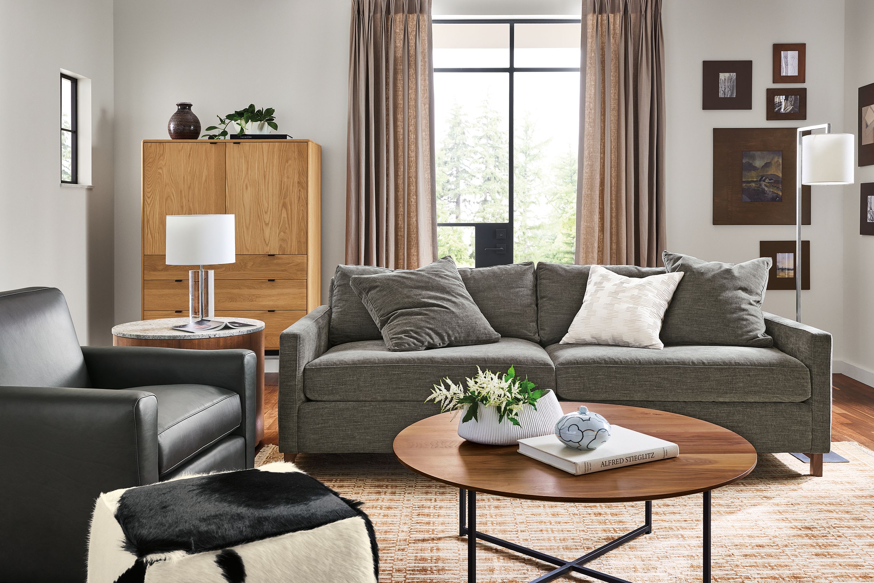 Living room with 91w Stevens sofa in Mori Graphite, Seth chair in Laino Black Leather and classic coffee table in walnut.