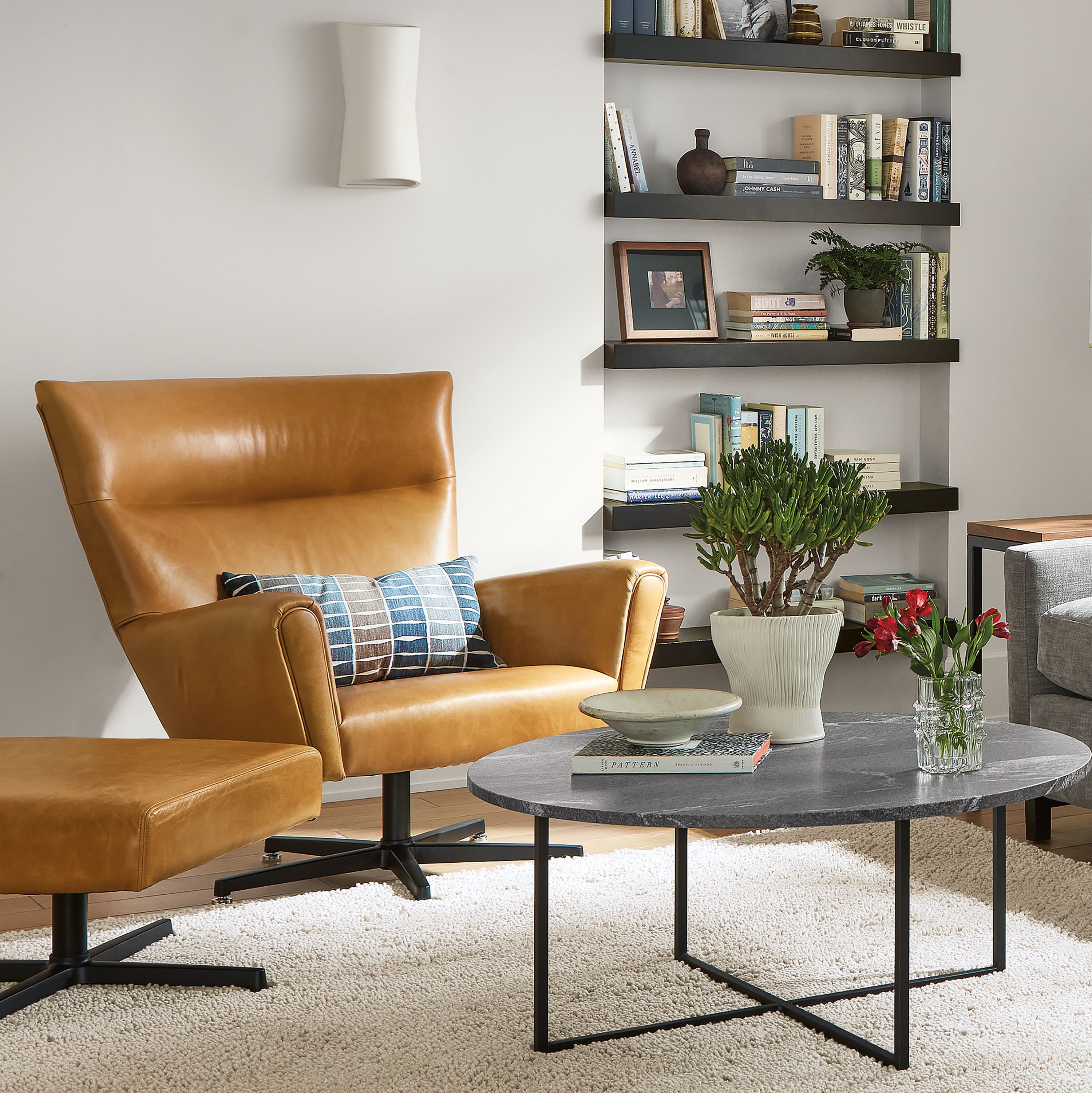 Living room with Stevens 106-inch Sofa with Right-Arm Chaise in Mori Fabric, classic coffee table and Boden swivel chair.