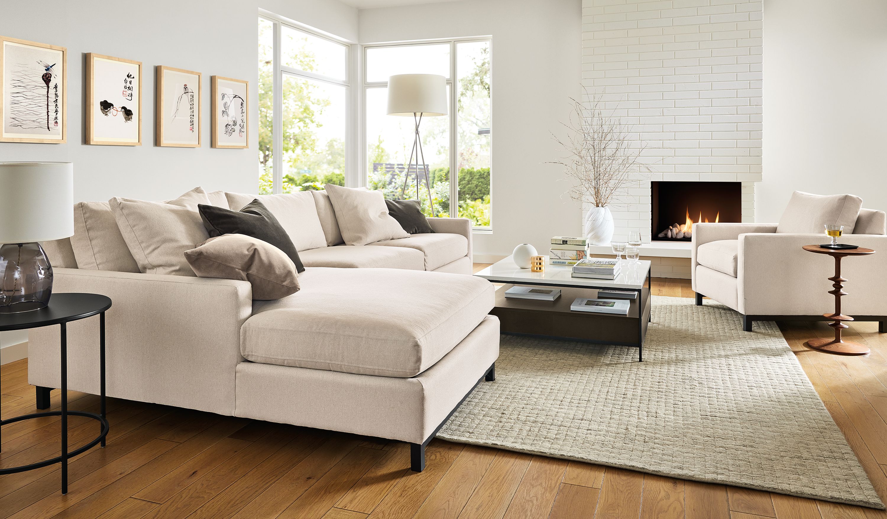 Living room with Stevens 116-wide sofa and Stevens chair in Hines Oatmeal and Safira 8 by 10 rug in grey.