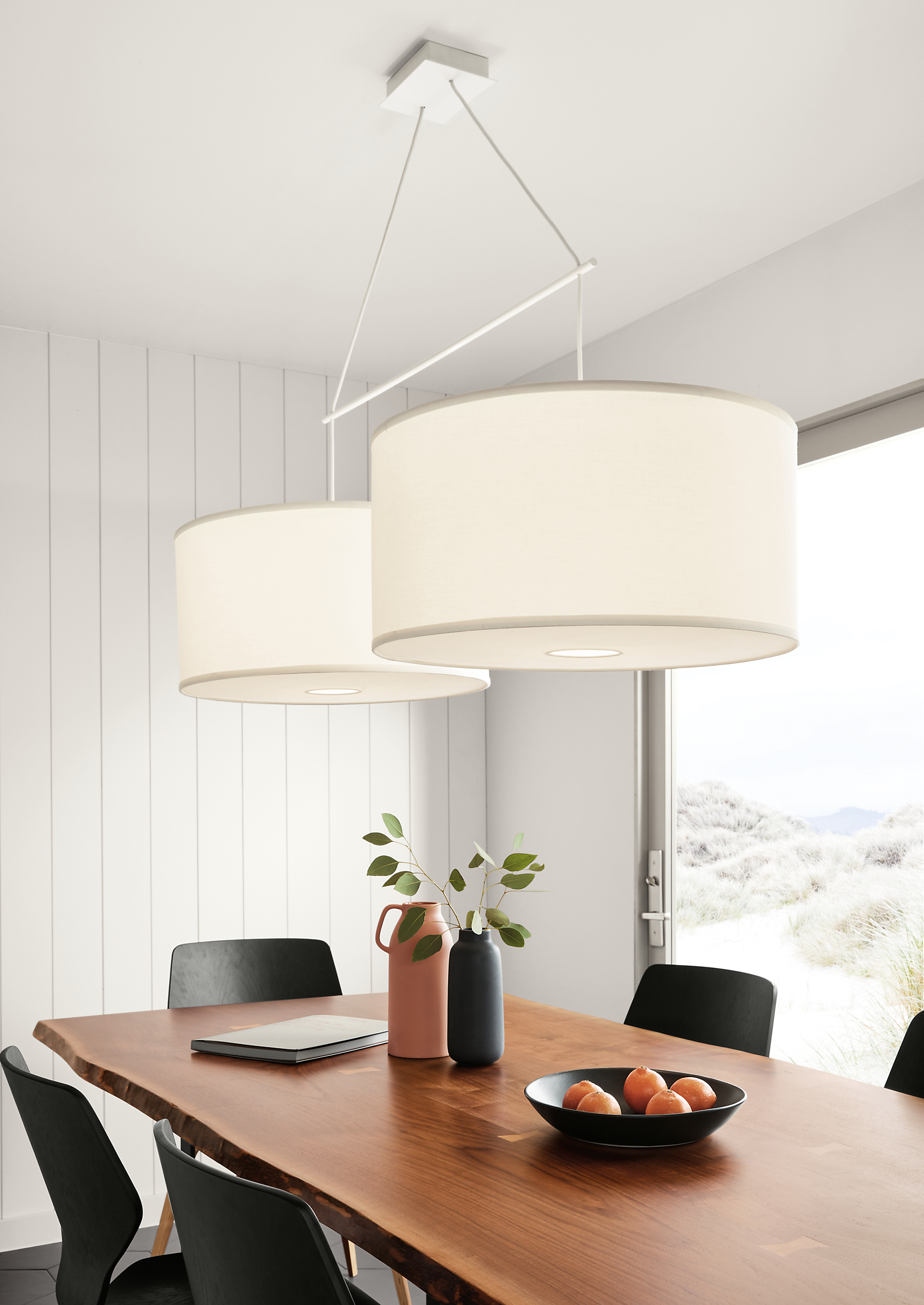 Detail of Studio round double pendant fixture with ivory white shades.