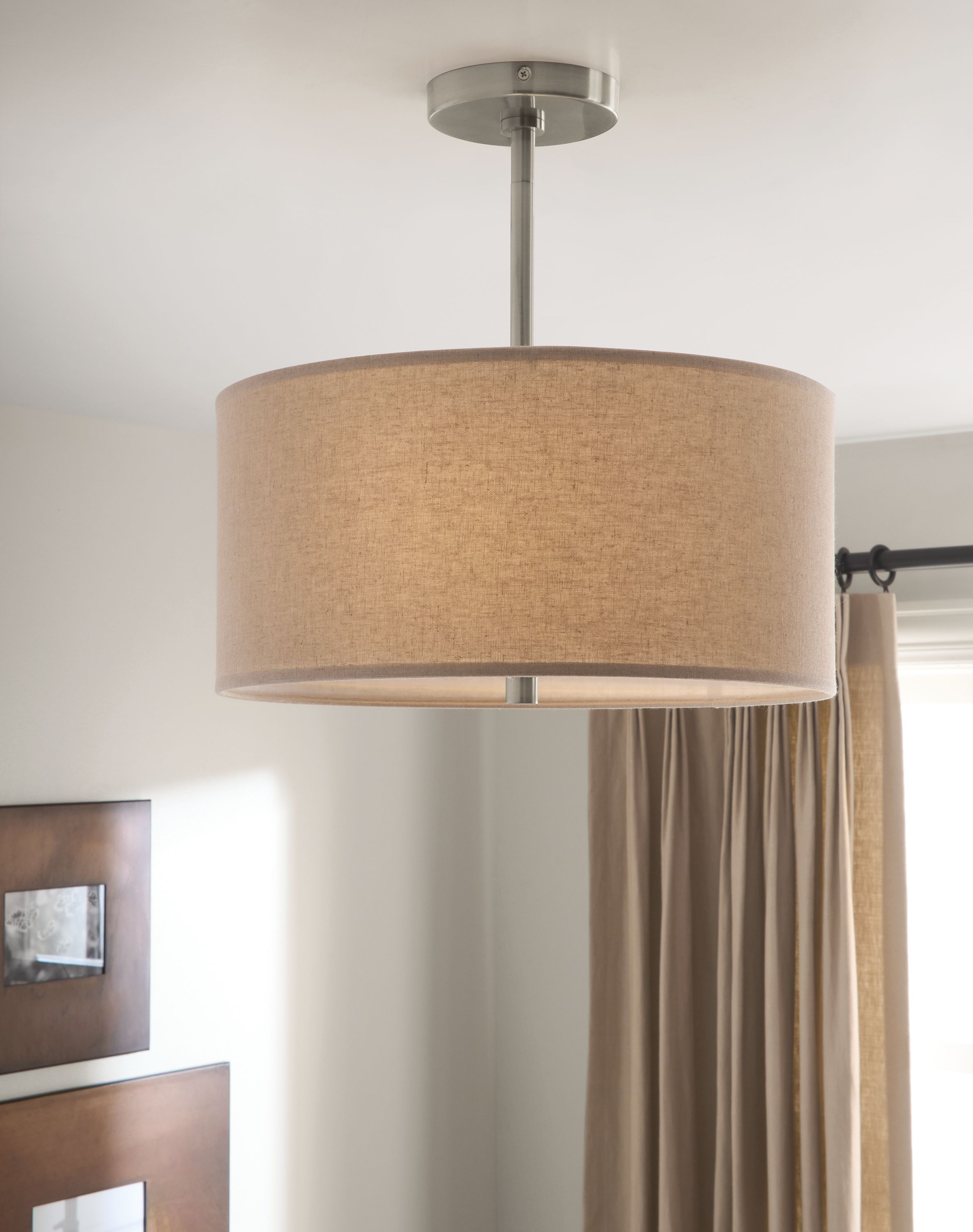 Detail of a Studio 16-diameter pendant flushmount in wheat and nickel in a living room.