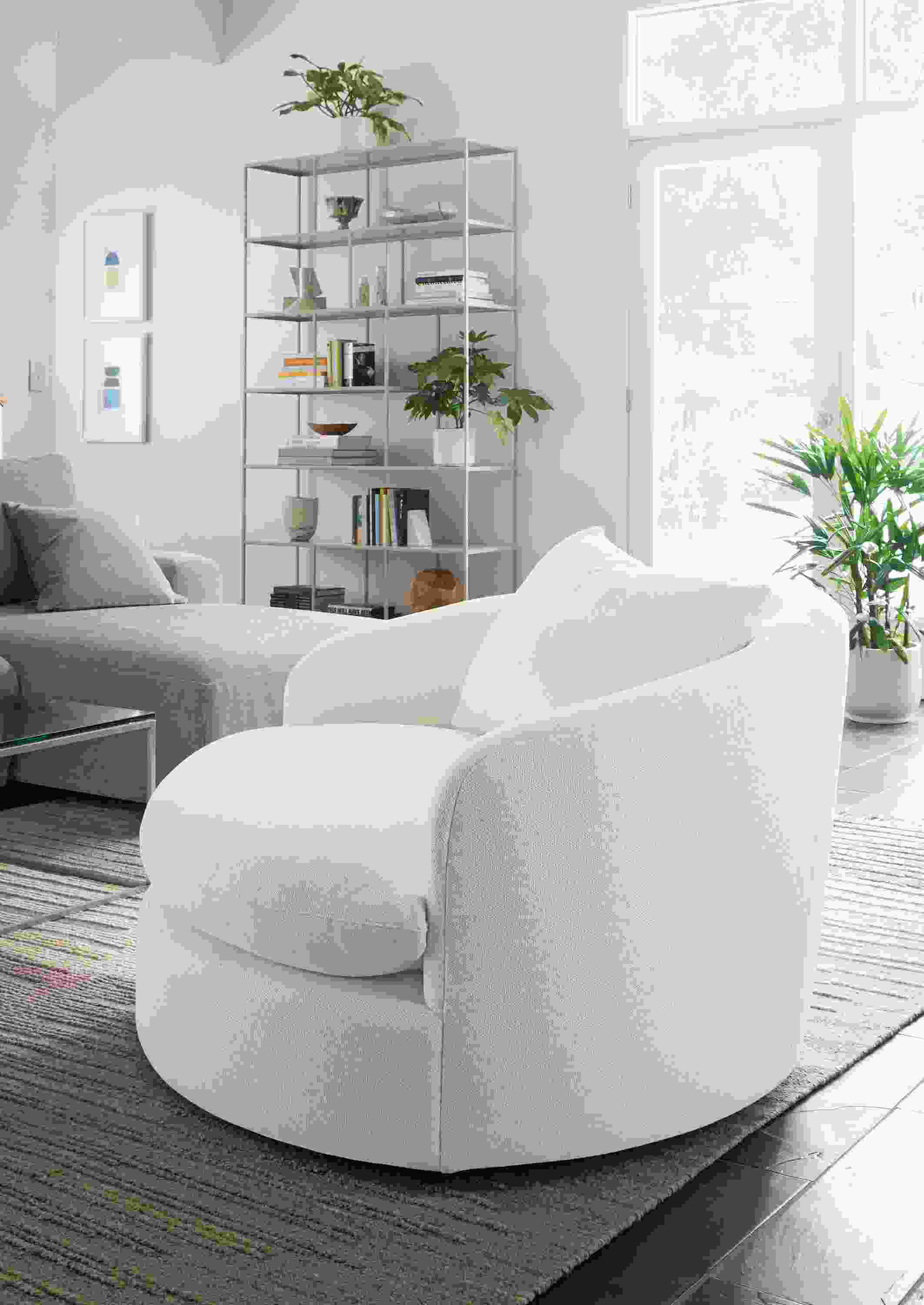 Living room with suri swivel chair in tepic white, fia sofa with right arm chaise in mori cement and tangier rug in natural.