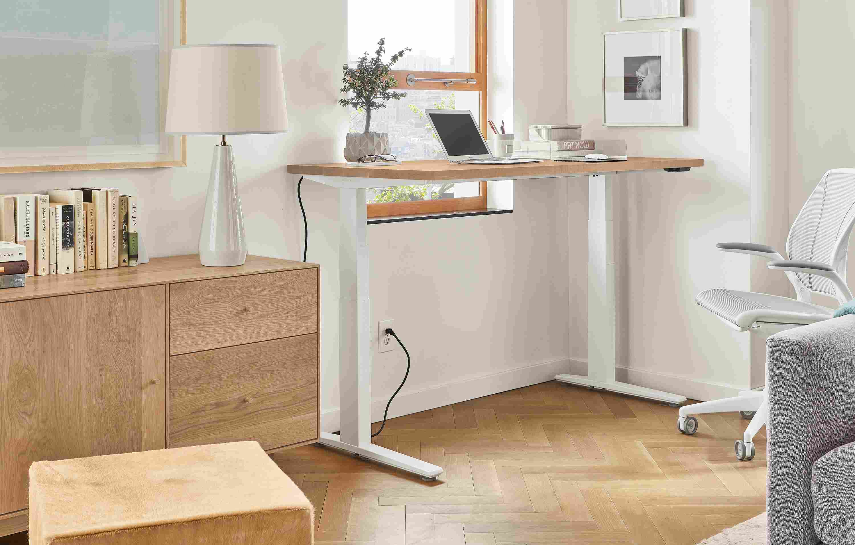 Home office setting with SW 60-wide standing desk in Rye in standing position and Diffrient World Office Chair in White.