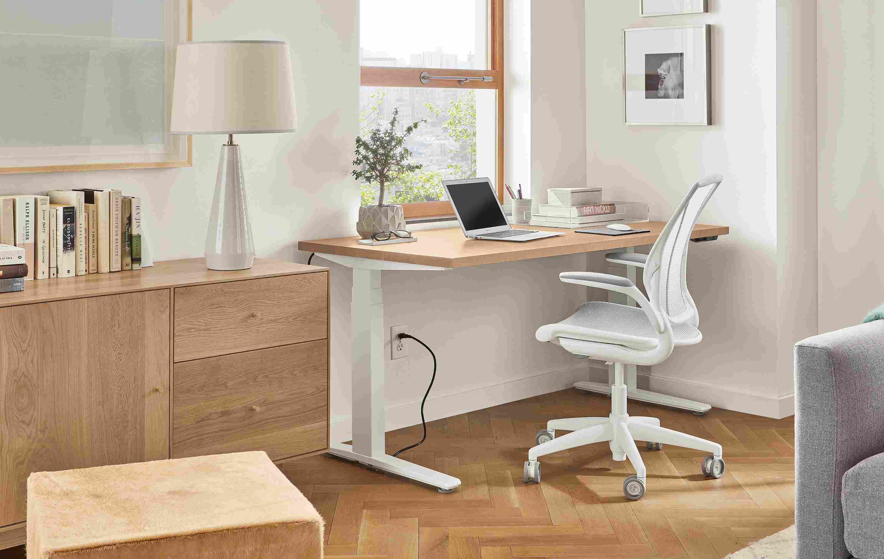 Home office setting with SW 60-wide standing desk in Rye in seated position and Diffrient World Office Chair in White.