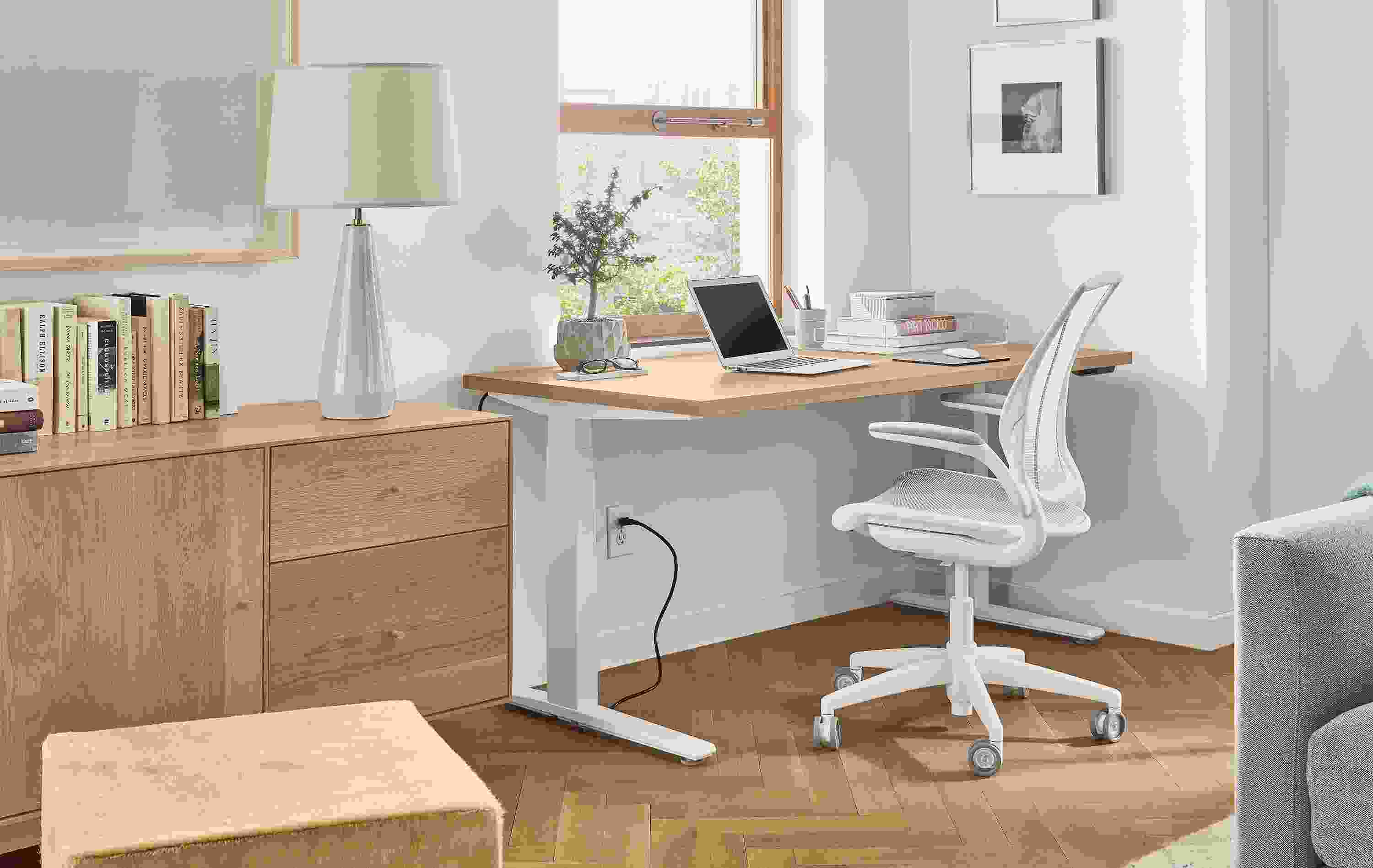 Home office setting with SW 60-wide standing desk in Rye in seated position and Diffrient World Office Chair in White.