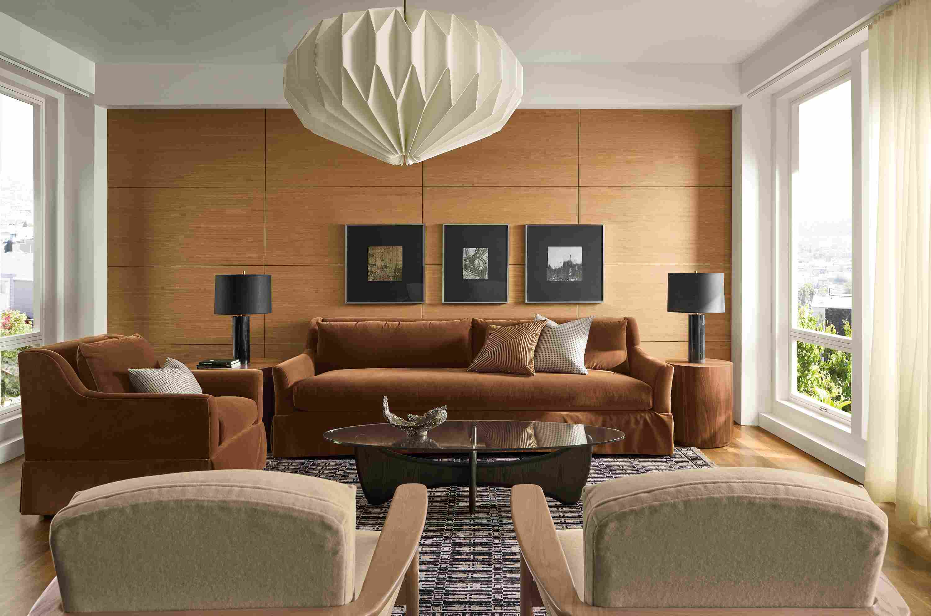 Sunny living room with Sybil skirted bench cushion sofa and Sybil chair in Redding Nutmeg and 2 Renew chairs in Terra Oatmeal.