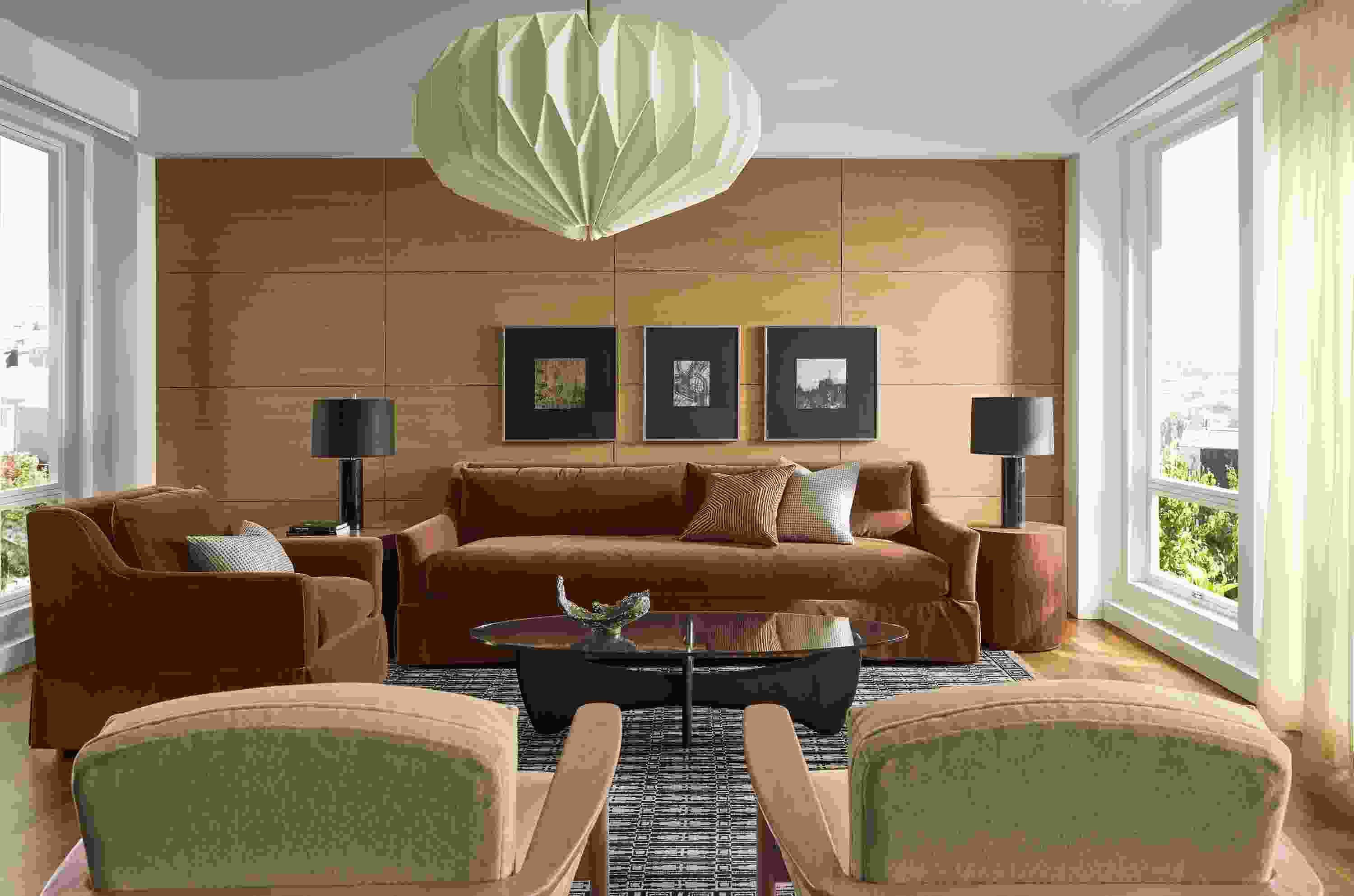 Sunny living room with Sybil skirted bench cushion sofa and Sybil chair in Redding Nutmeg and 2 Renew chairs in Terra Oatmeal.