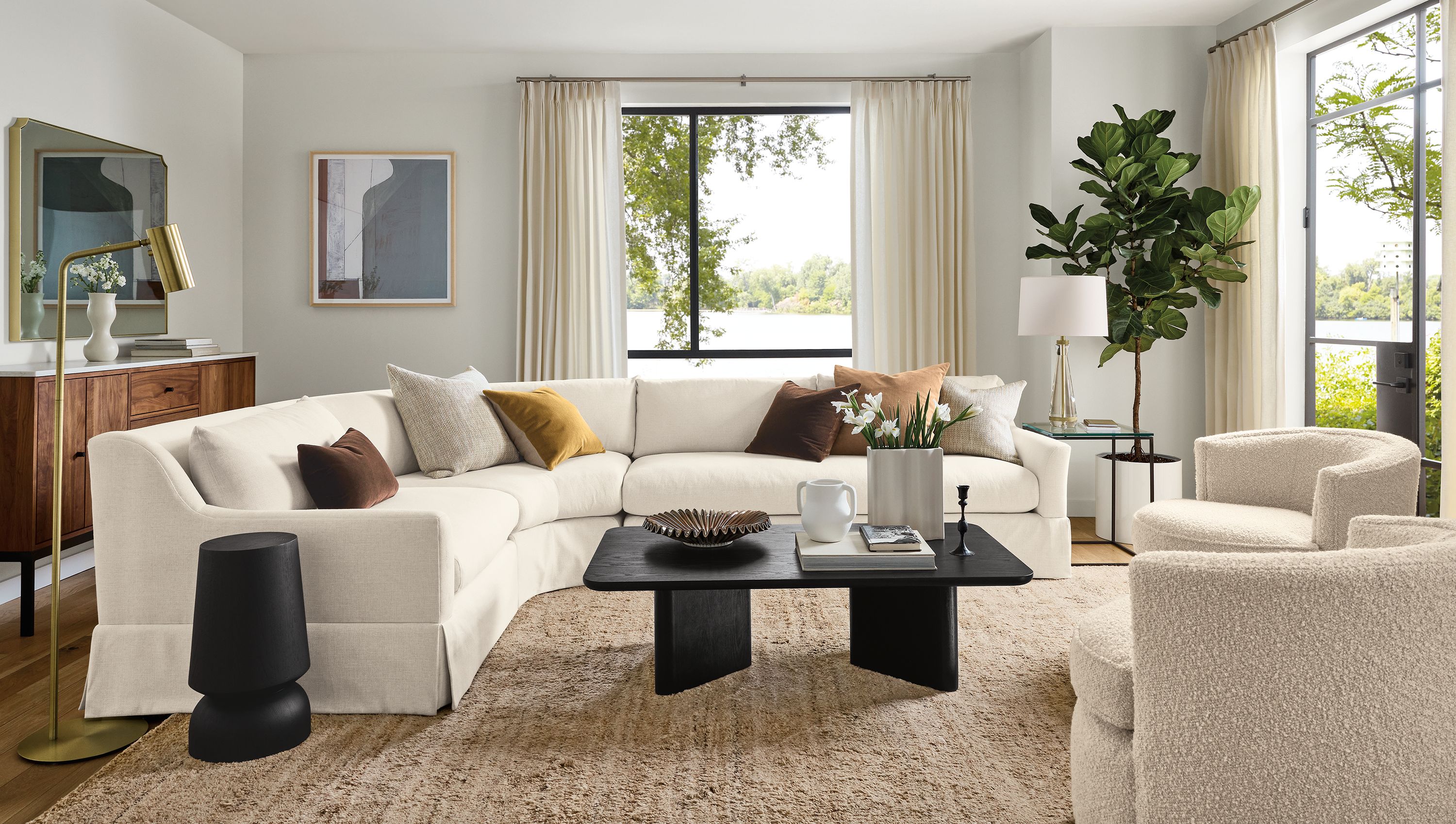 Living room with Sybil 3-piece curved sectional in Sumner Ivory and 2 Otis swivel chairs in Dornick Ivory.