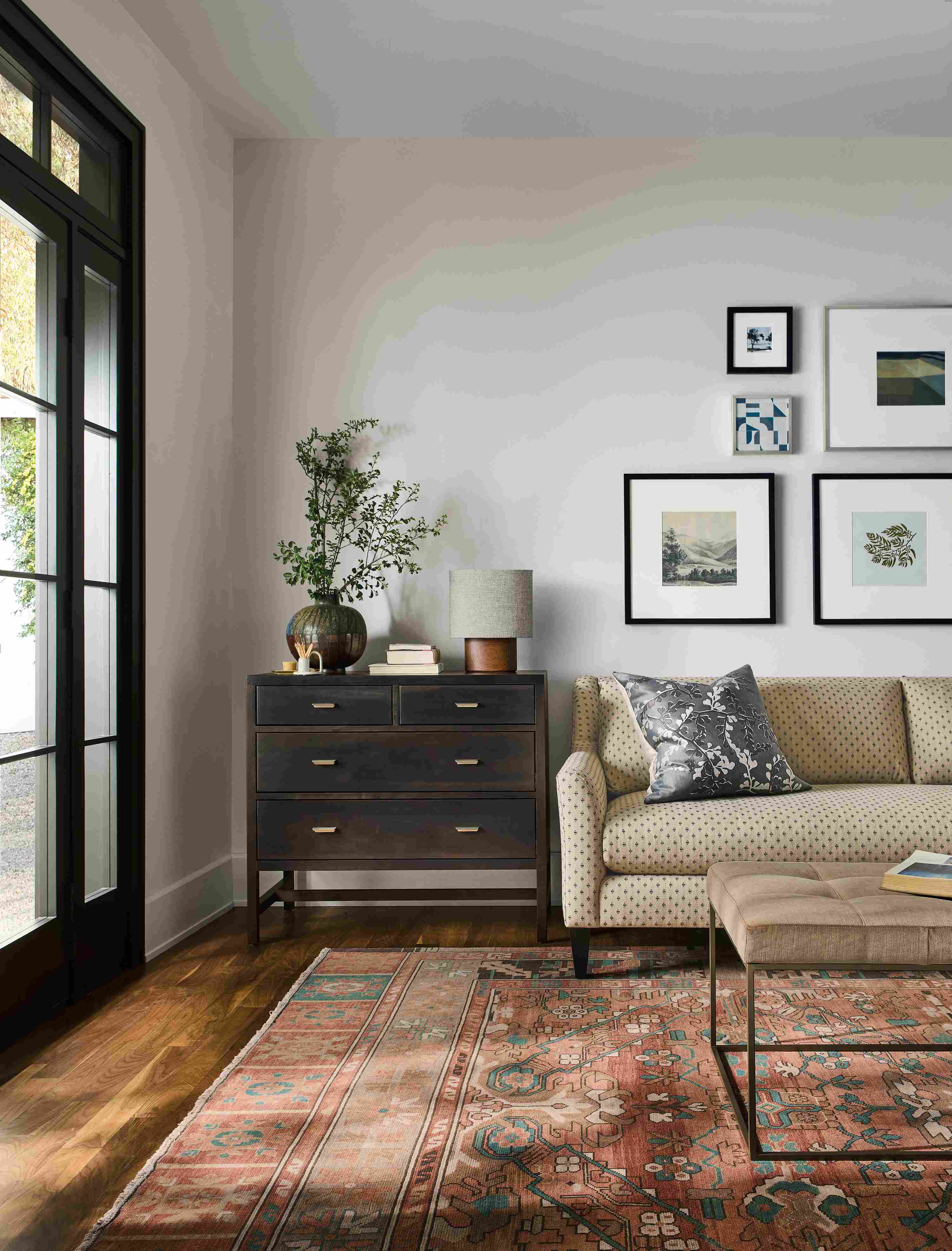 Living room with Sybil bench cushion sofa in Lockwood Natural, Berkeley 4-drawer dresser in charcoal and Kayseri rug in terracotta.