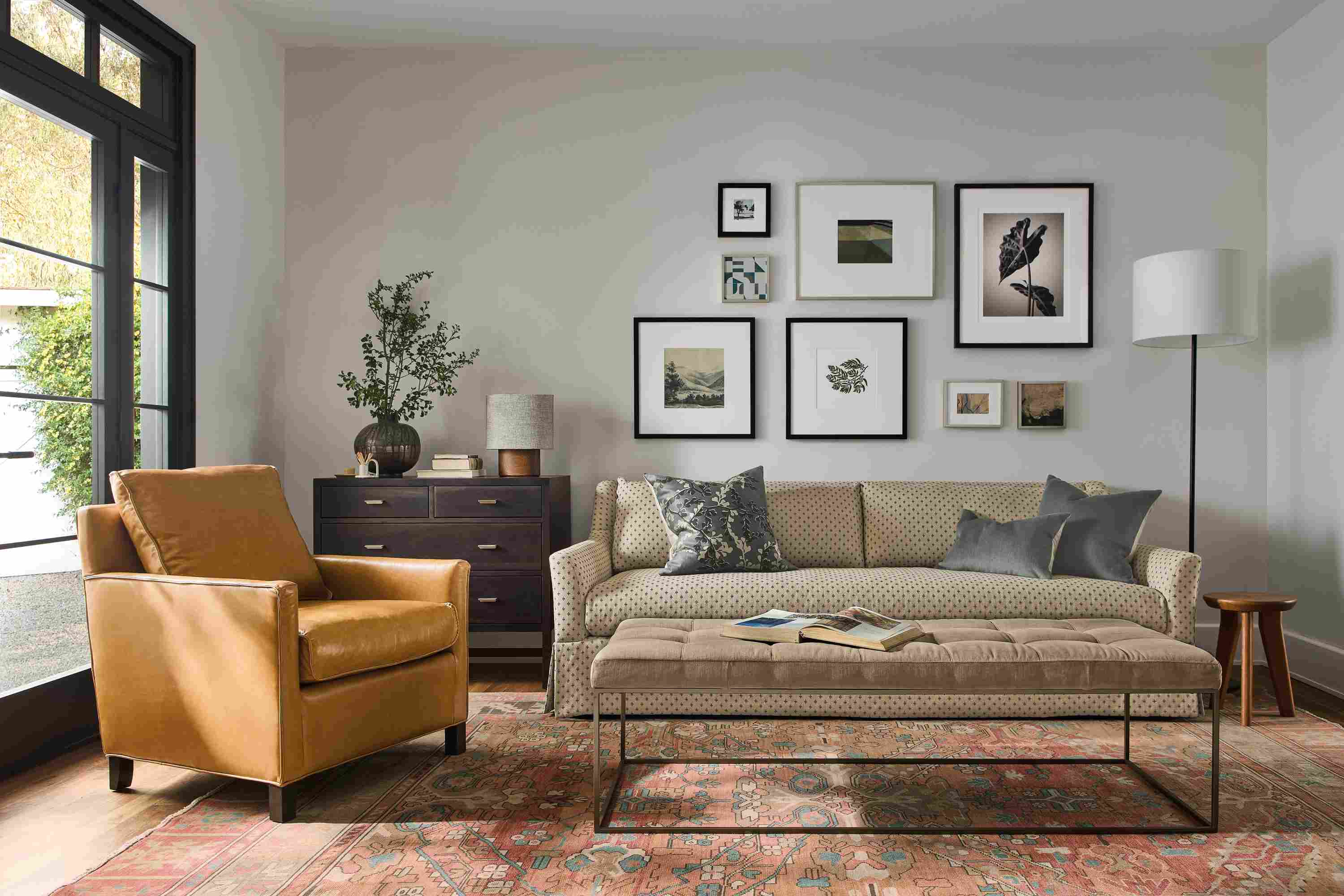 Living room with Sybil skirted sofa in Lockwood Natural, Bram chair in Vento Camel and Tyne bench in Windsor Otter.