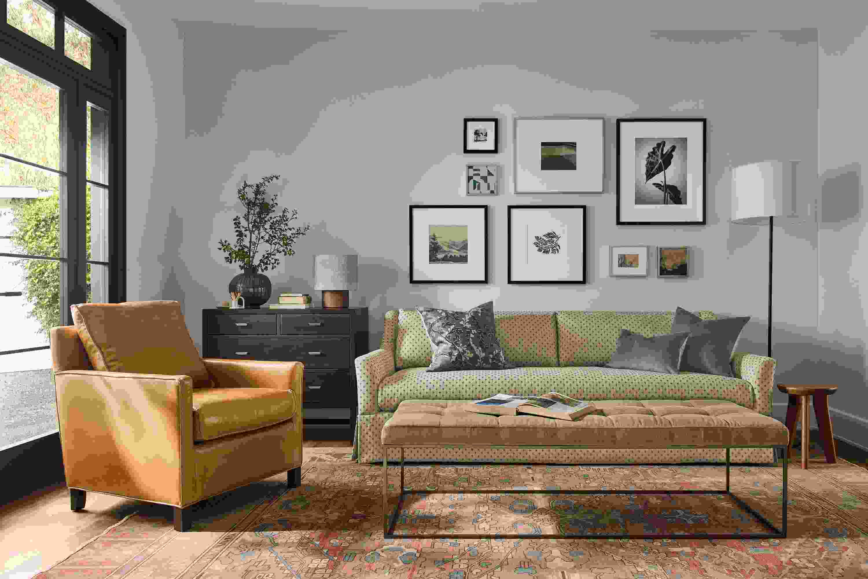 Living room with Sybil skirted sofa in Lockwood Natural, Bram chair in Vento Camel and Tyne bench in Windsor Otter.