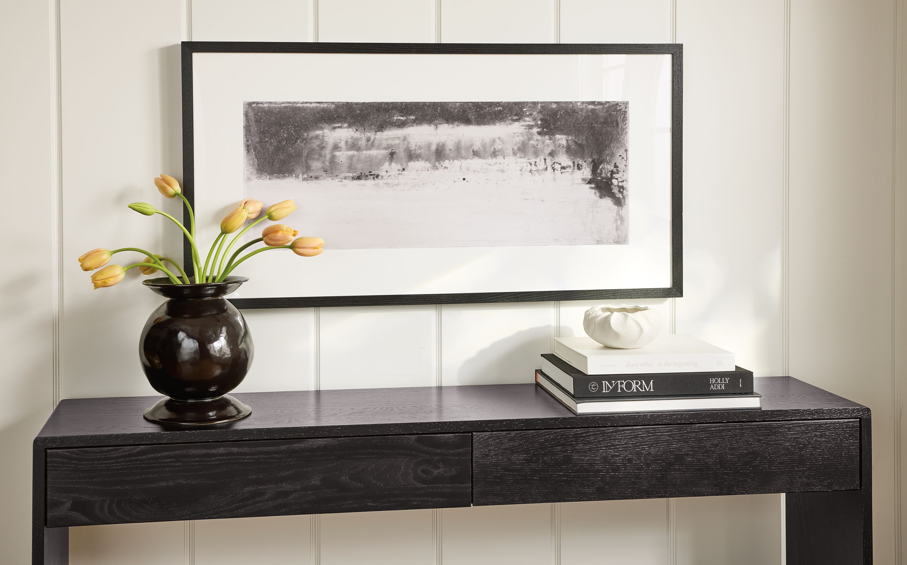Wall art from Chantal Talbot entitled little seas hanging on a wall above a graft 60-wide console table in charcoal reclaimed oak.