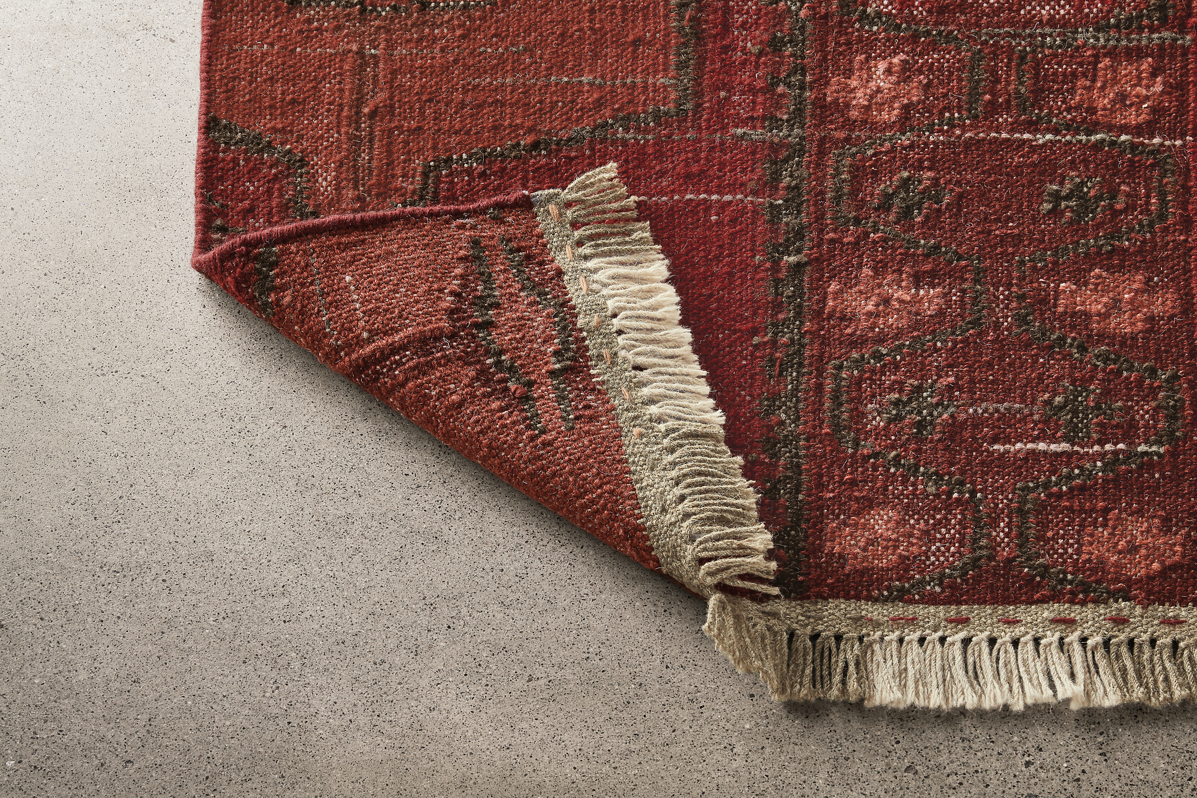 Detail of Tamsa 2x3 rug in rust.