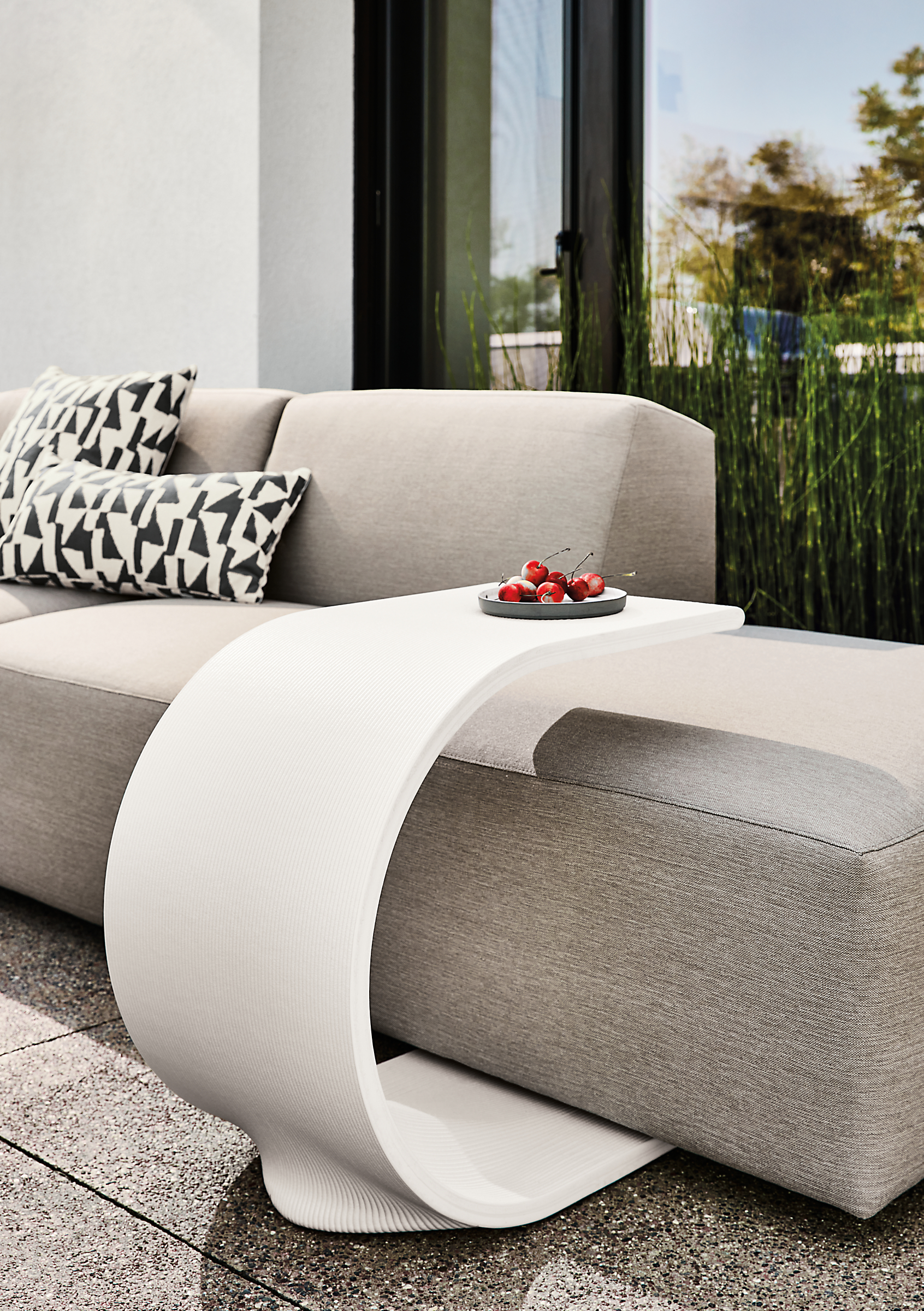 Tangent outdoor c-table in white with Drift sectional in Pelham cement fabric.