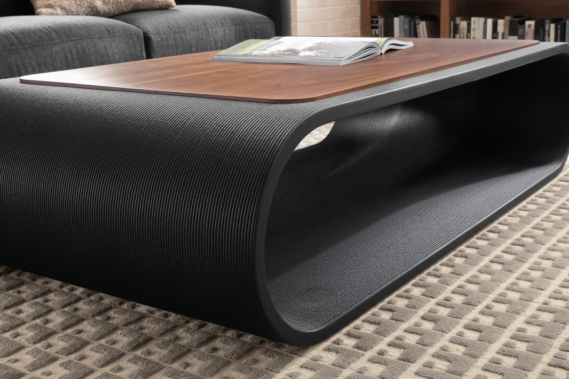 Detail of Tangent 60-wide Coffee Table in black with walnut inset top.