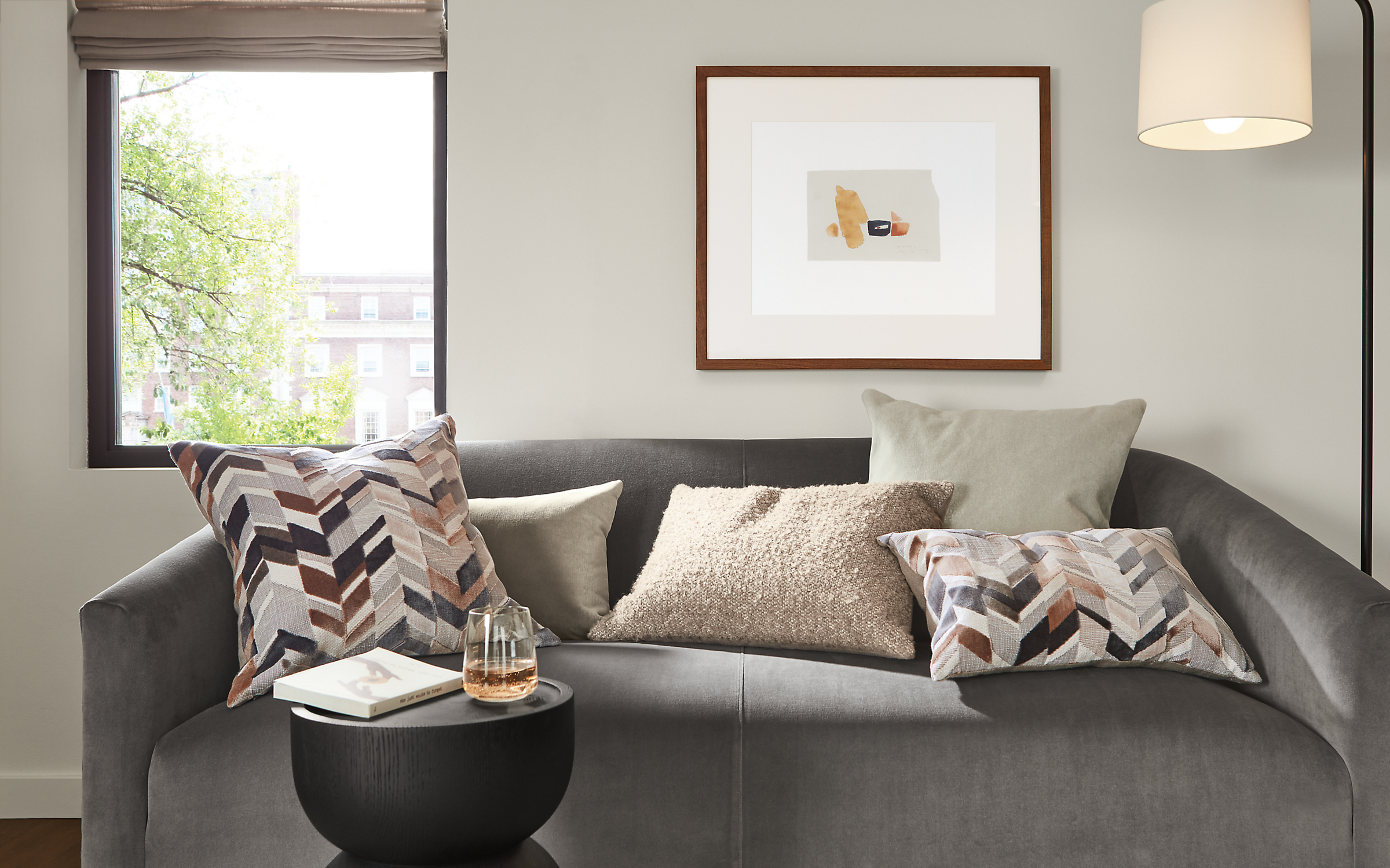 Living room with various Tango, Velvet, Palmer pillows on Ada sofa in Vance Grey.