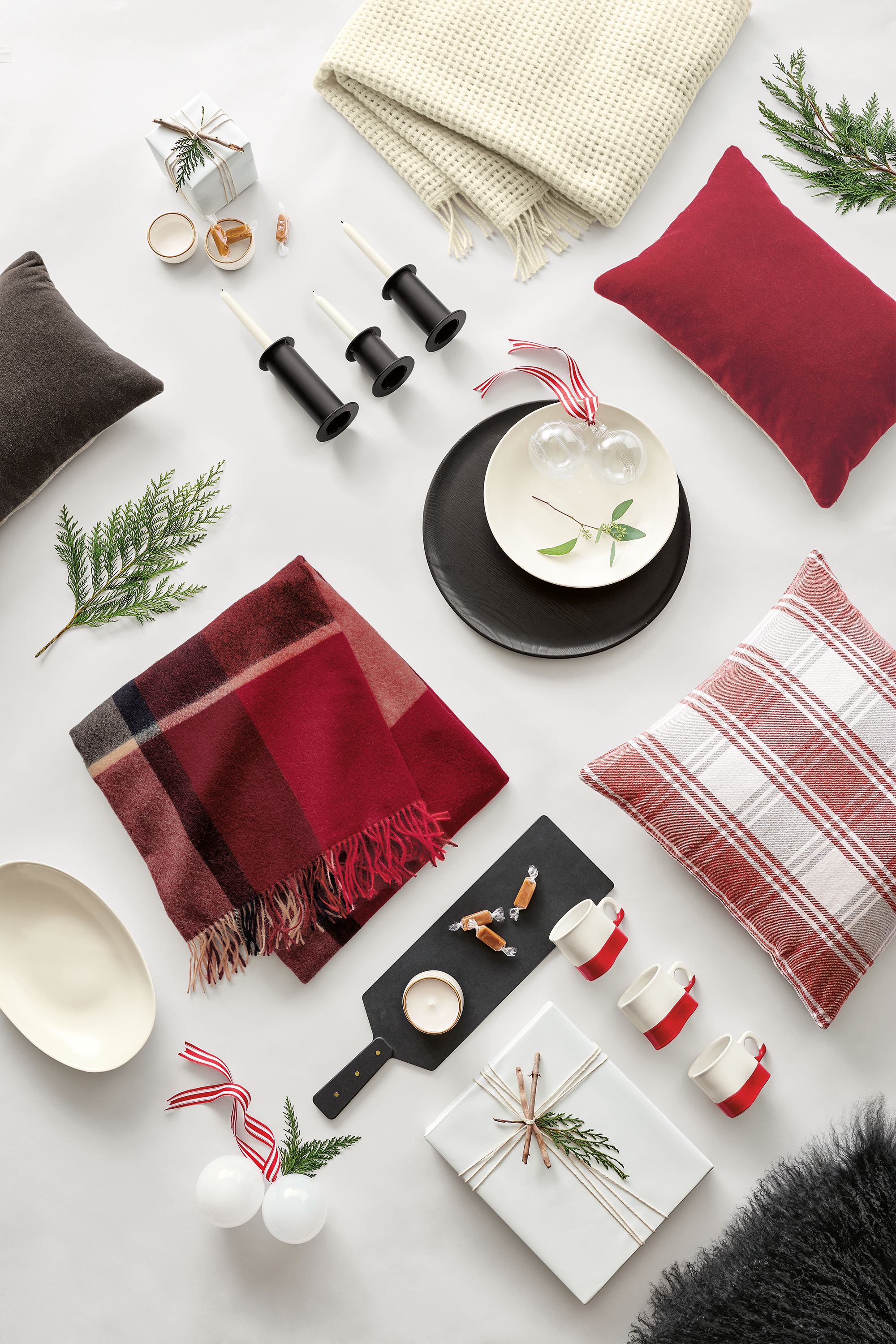 Detail of holiday home decor items including red/ivory Tartan throw pillow.