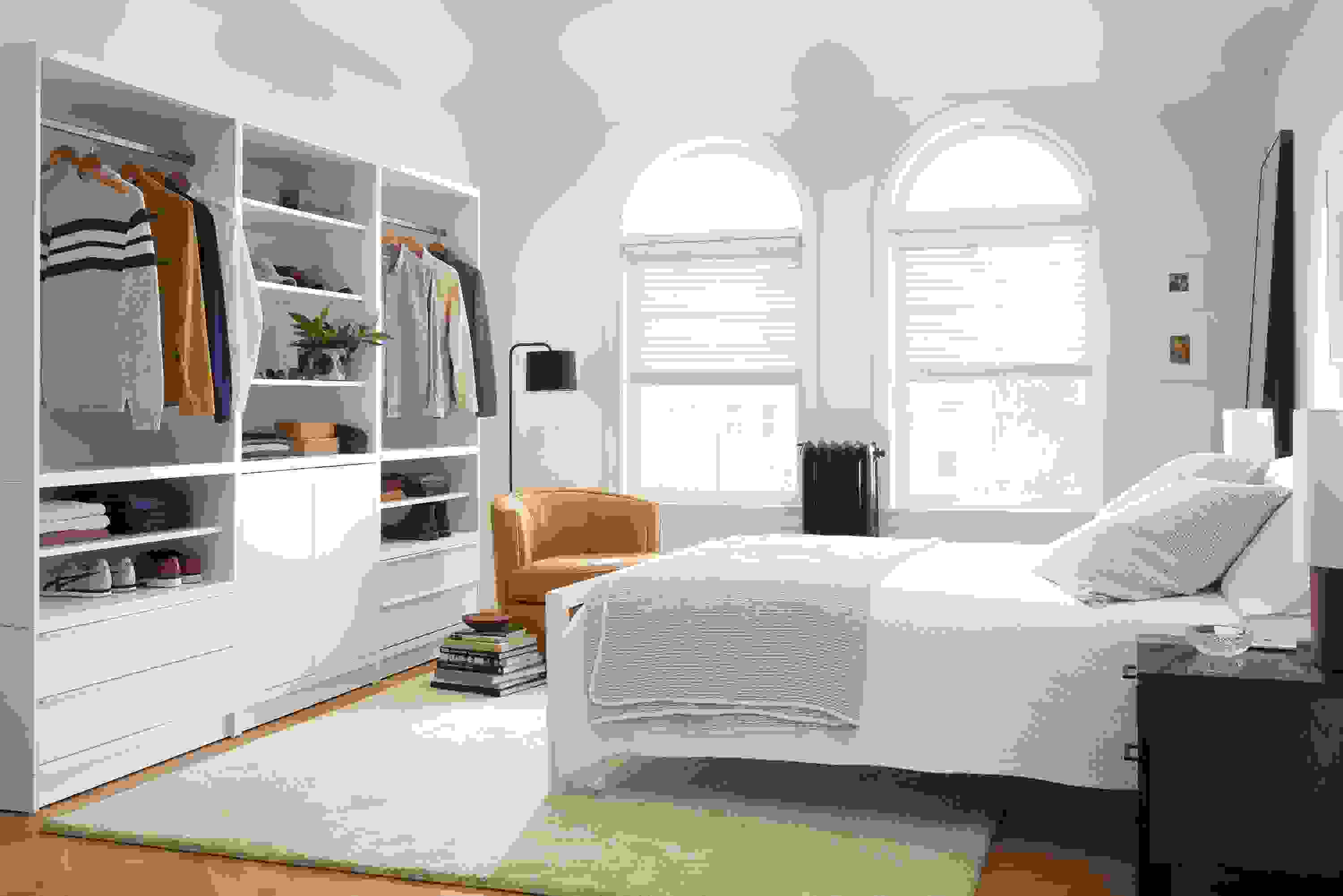 bedroom with taylor clothing bar wall unit storage in white.