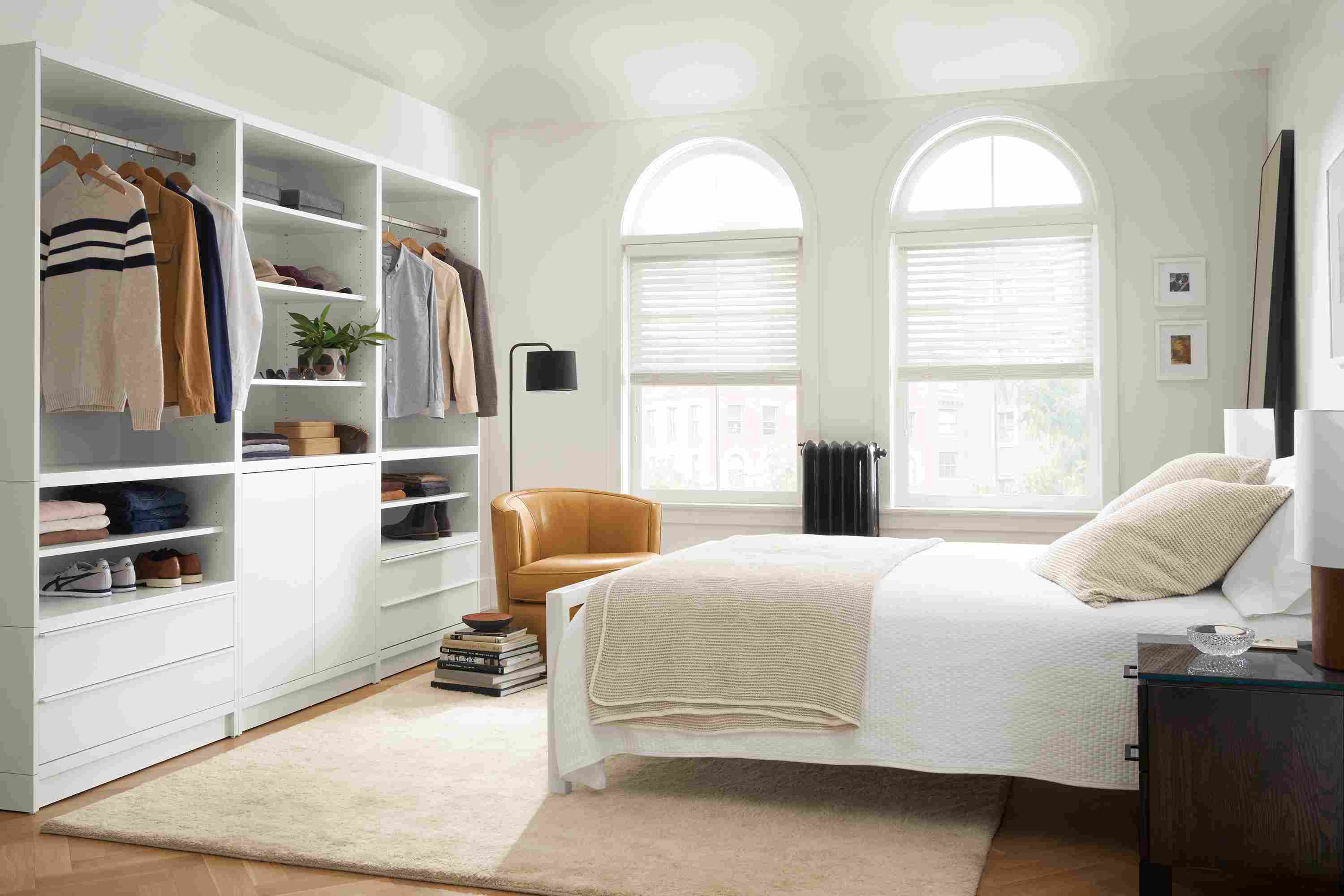 Bedroom with Taylor clothing bar wall unit storage in white.