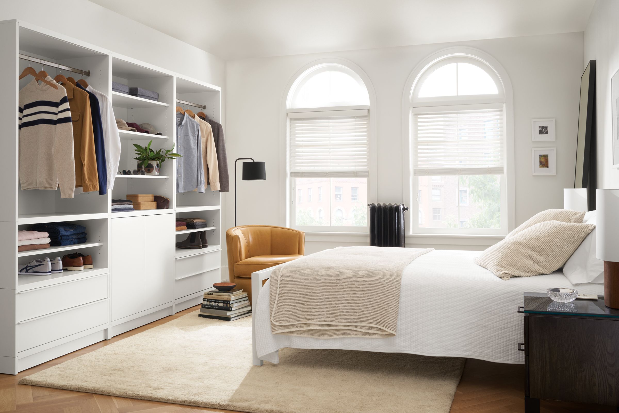 bedroom with taylor clothing bar wall unit storage in white.