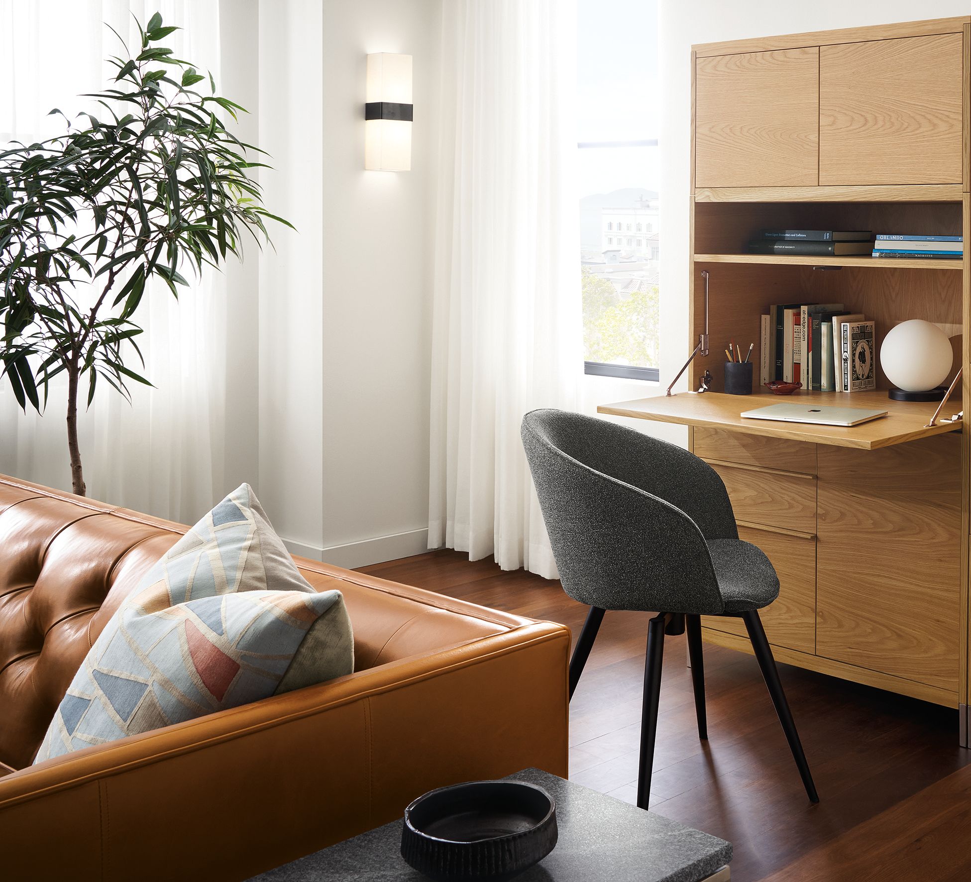 Detail of Taylor office wall unit in white oak with drop-down desk extended and Sylvan swivel side chair Radford Grey.