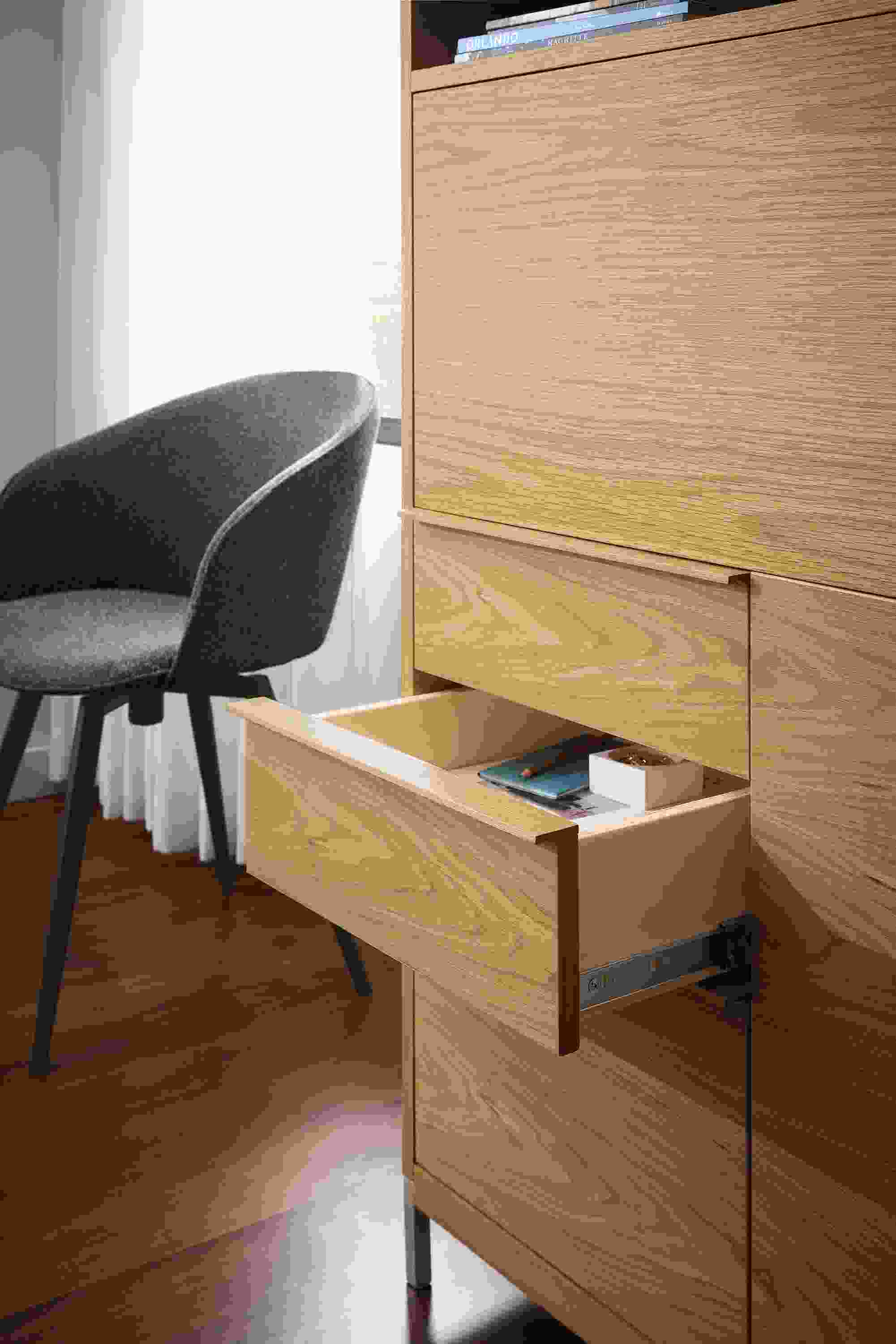Detail of open drawer of Taylor office wall unit in white oak and Sylvan swivel side chair in Radford Grey and graphite.
