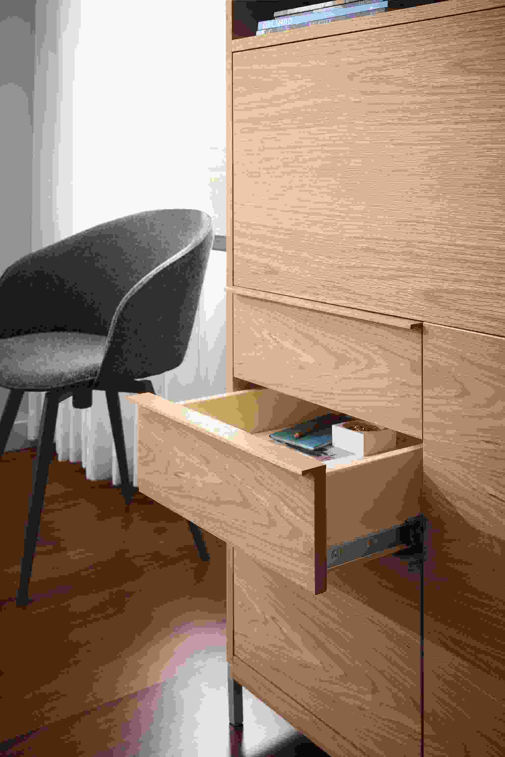 Detail of drawer of taylor office wall unit storage piece in rye on red oak shown with one drawer open.