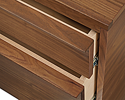 close-up of corner of taylor storage cabinet drawers partially open.