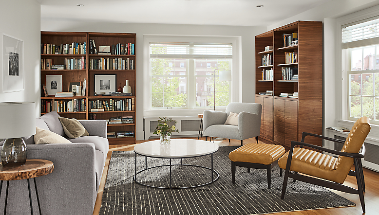 living room with taylor storage cabinets in walnut, bria rug, callan chair, matteo chair, clemens sofa.