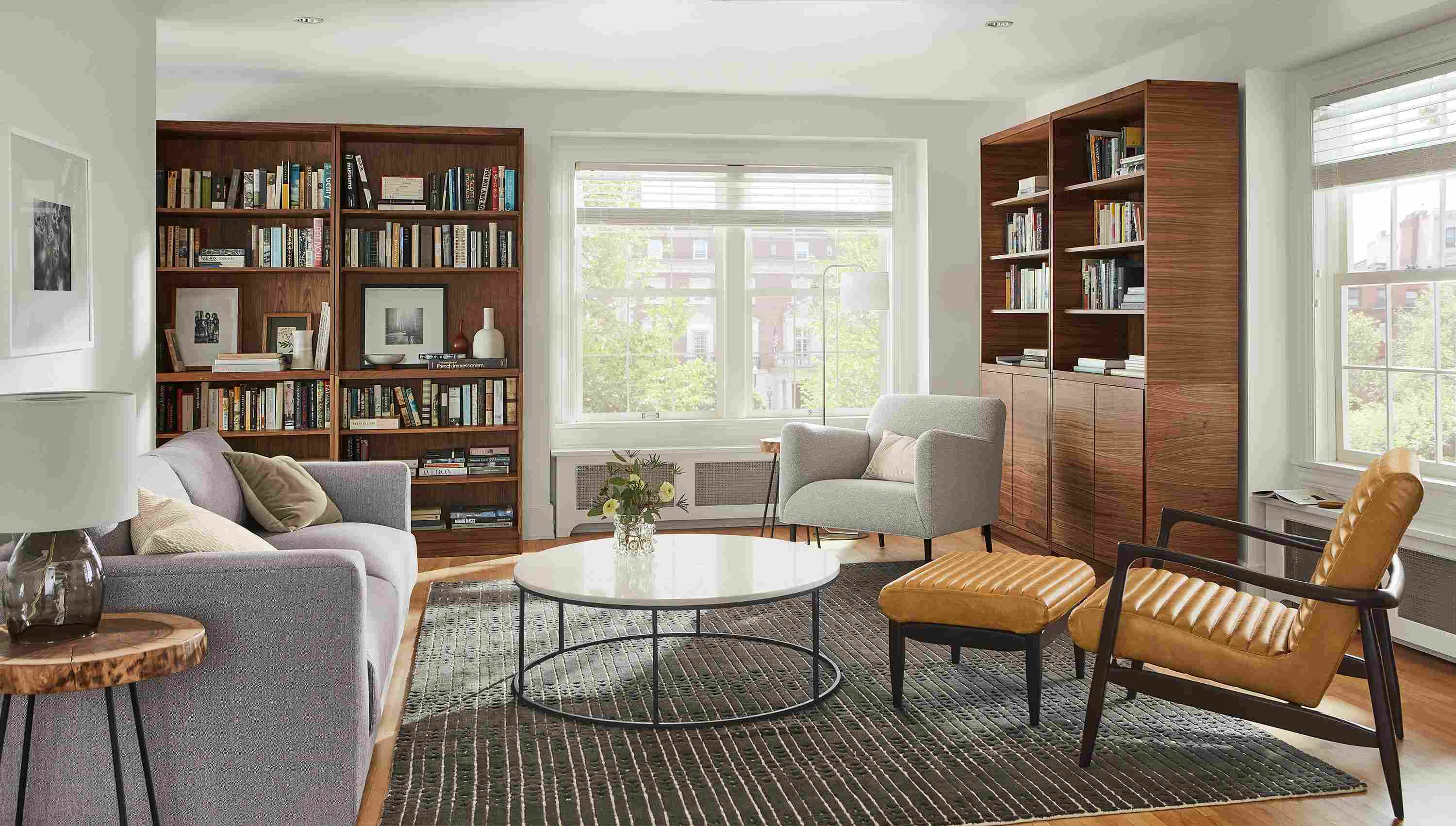 Living room with Taylor storage cabinets in walnut, Bria rug in charcoal, callan chair, matteo chair and clemens sofa.