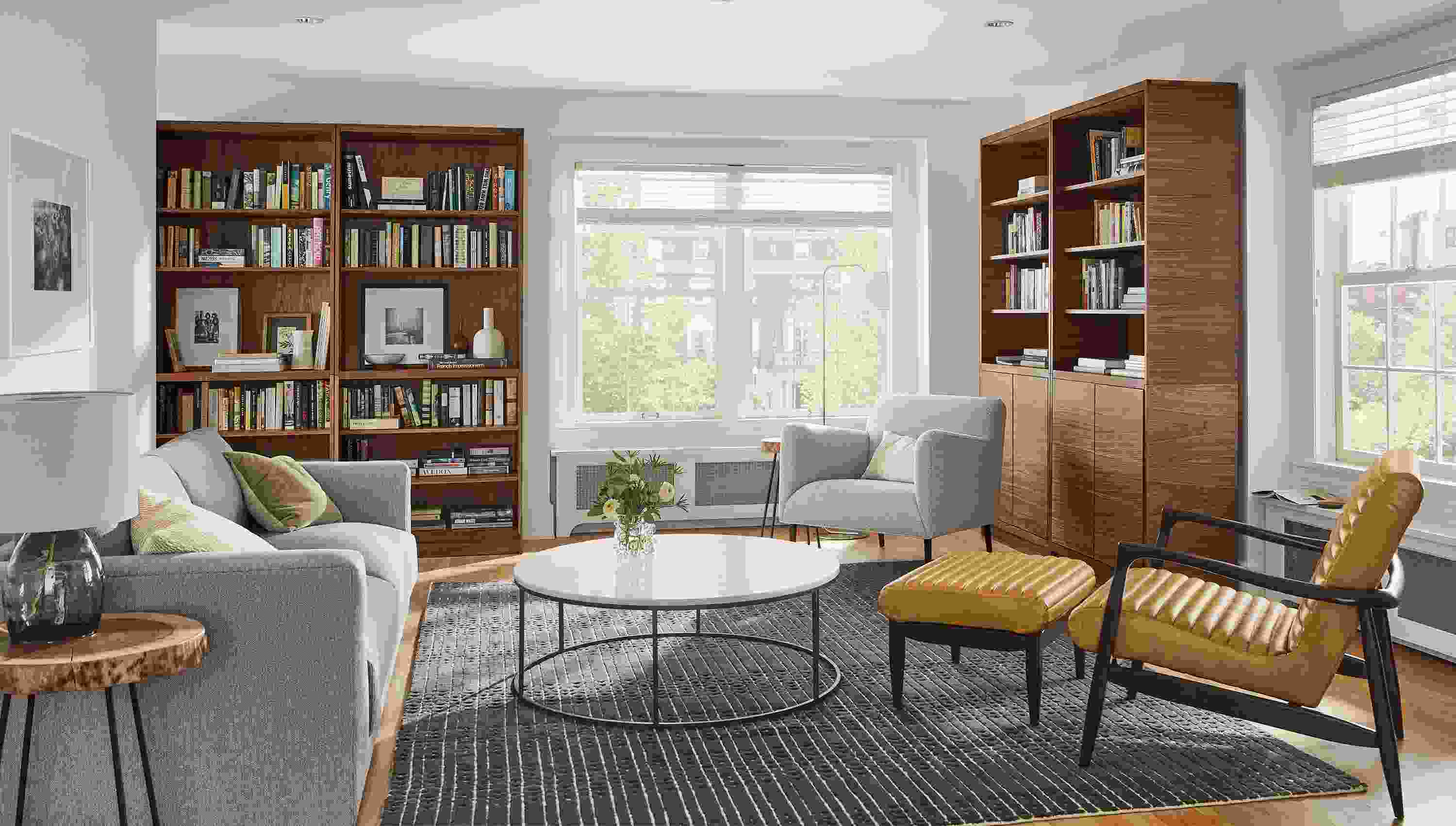Living room with Taylor storage cabinets in walnut, Bria rug in charcoal, callan chair, matteo chair and clemens sofa.