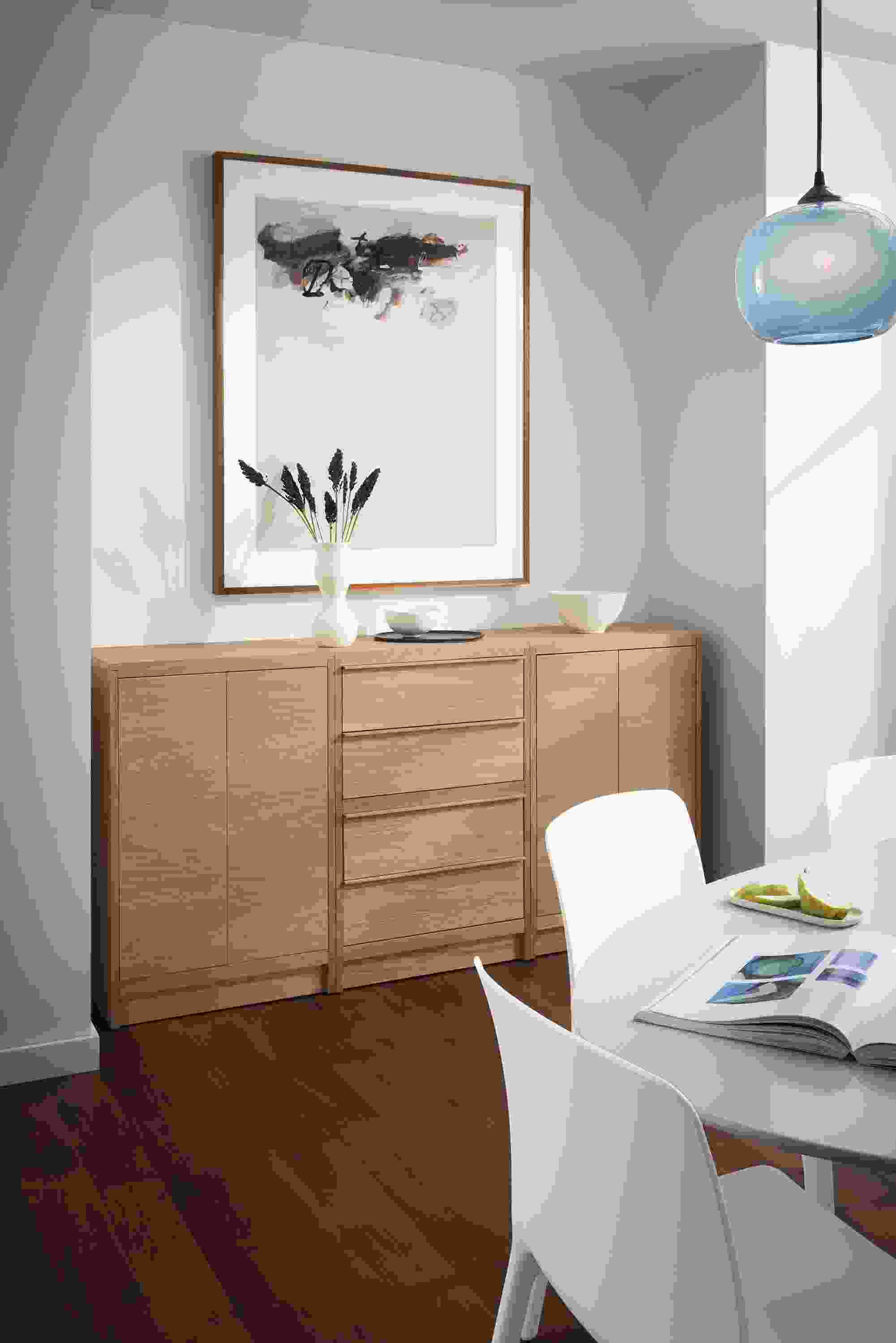 Dining room with Taylor storage cabinet in rye on red oak with wood base, Aria table, Tiffany chairs and Gale pendant.