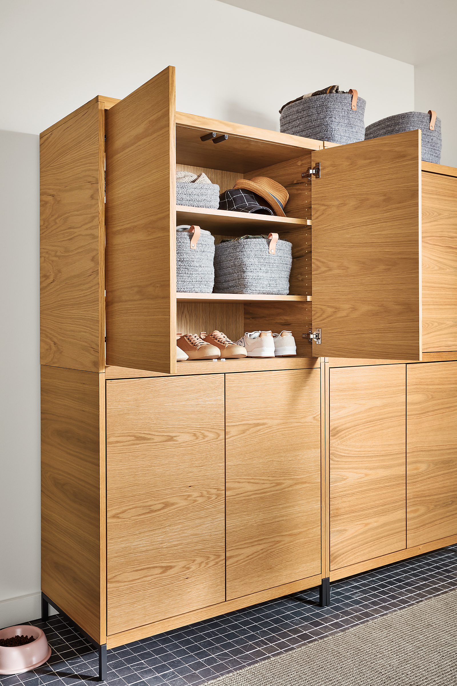 taylor storage cabinet in white oak in entryway with top doors open to reveal shoe storage.