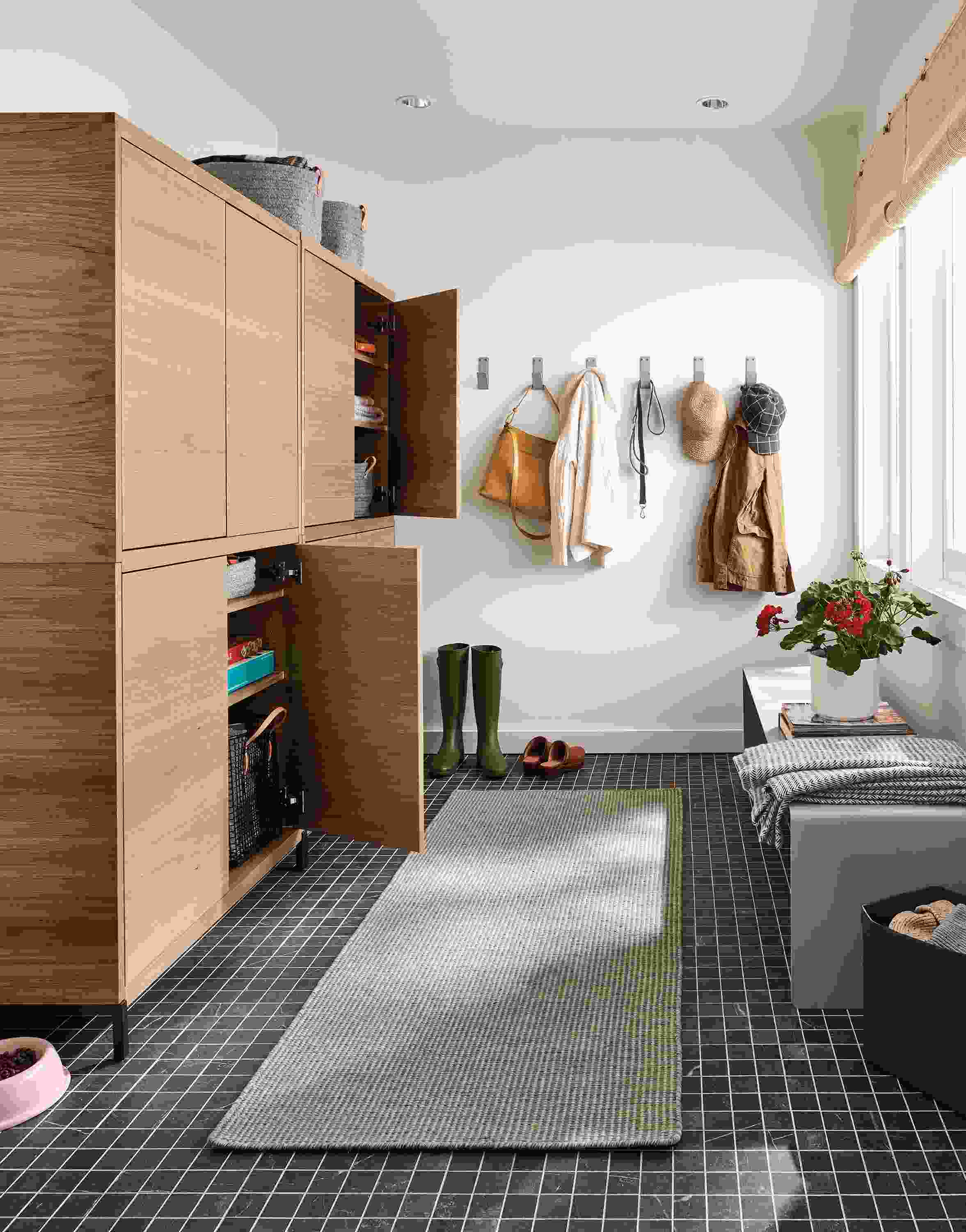 Entryway with Taylor cabinets in rye on red oak with 2 doors open.