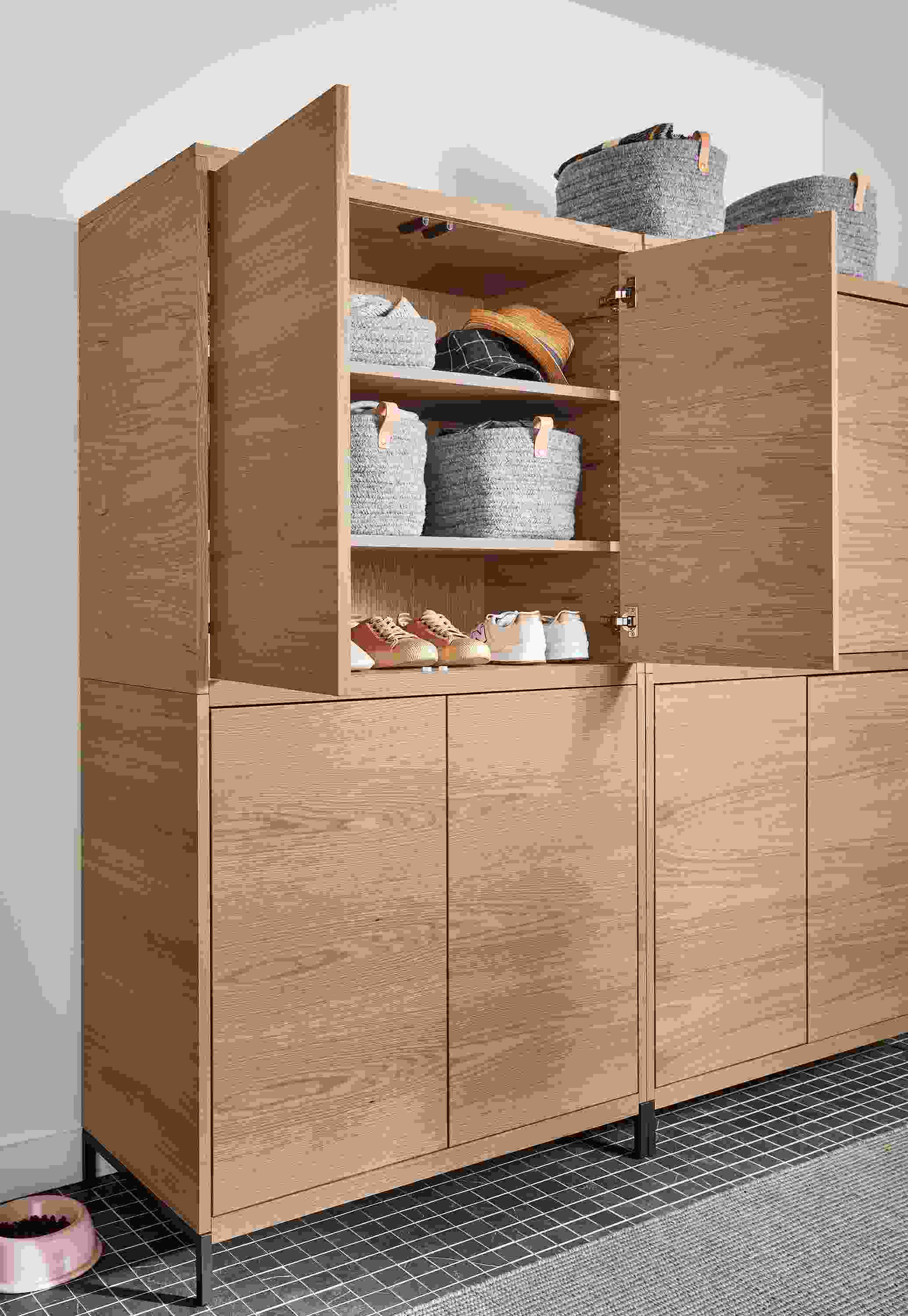 Taylor storage cabinet in rye on red oak in entryway with top doors open to reveal storage.