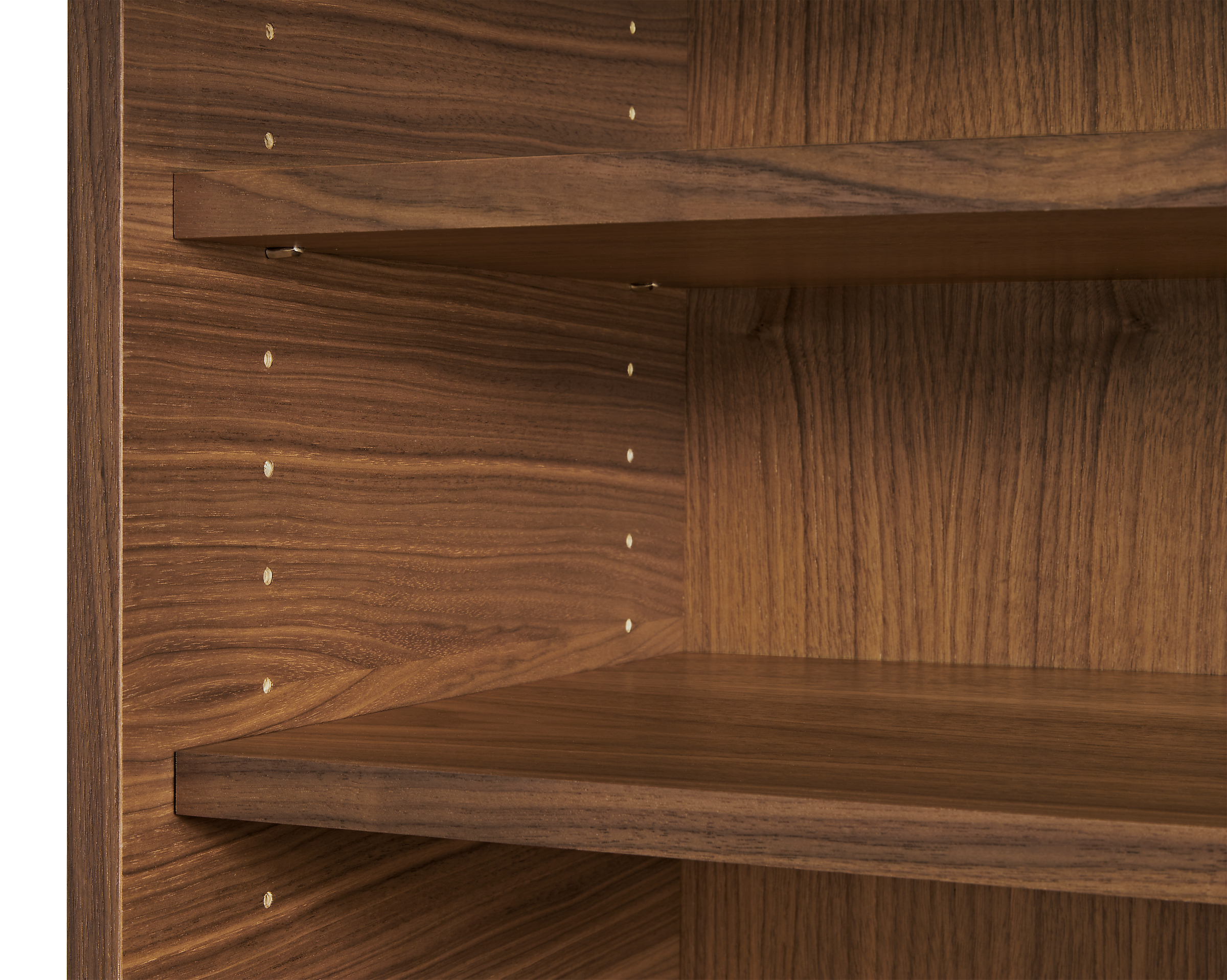close-up of taylor wood shelves in walnut in open space piece.