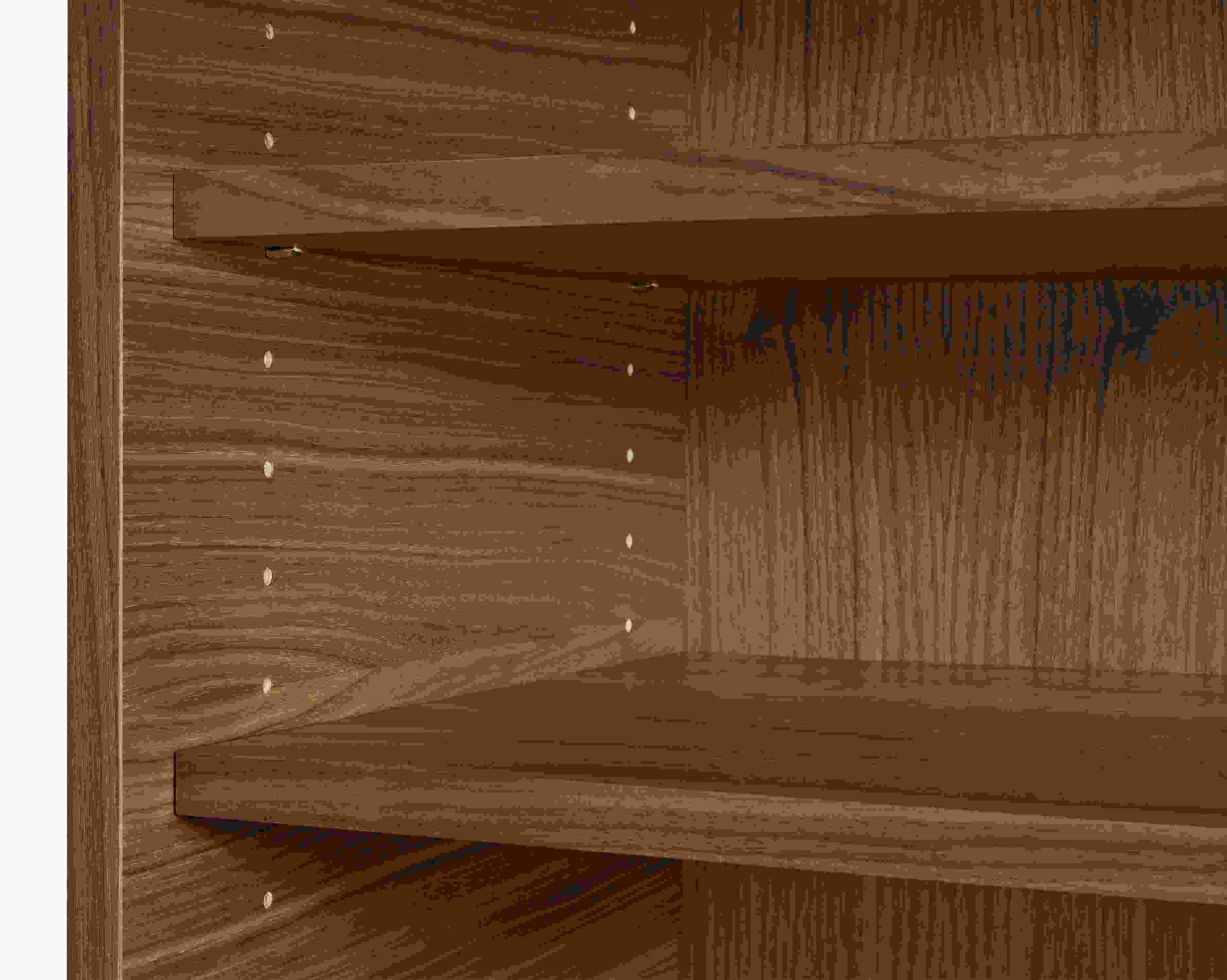 close-up of taylor wood shelves in walnut in open space piece.
