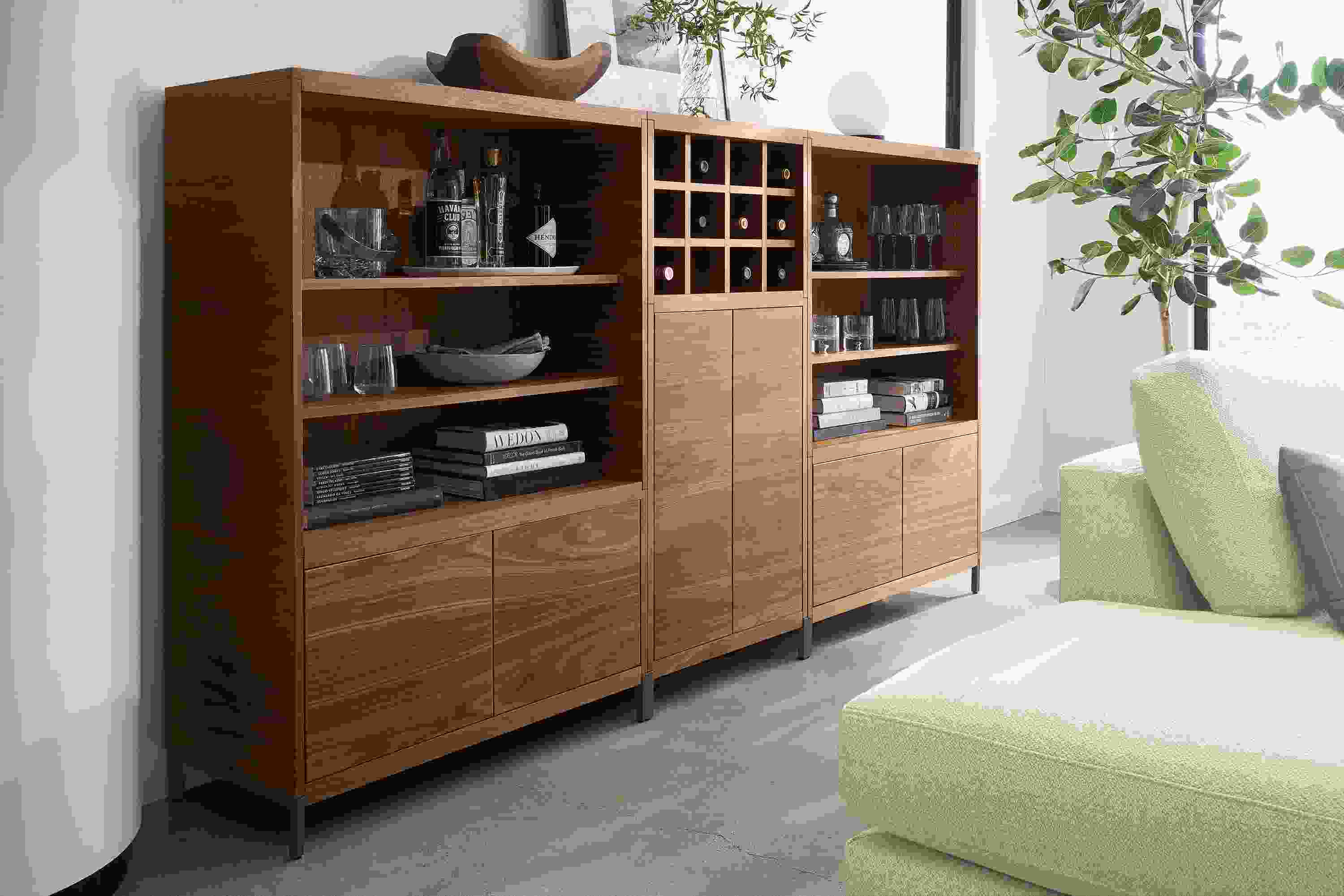Living room with Taylor bookcase wall unit in walnut with graphite steel base.