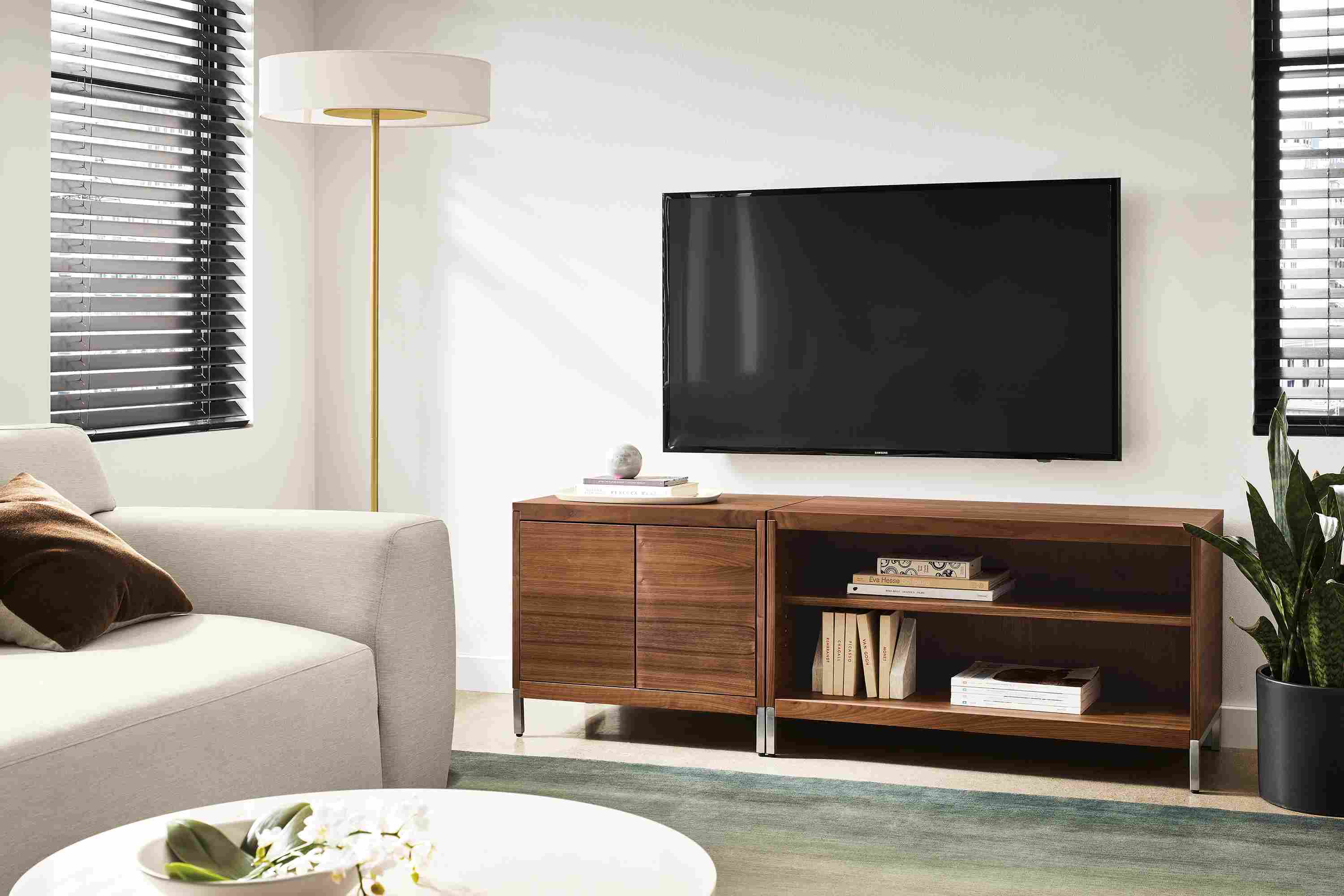 Living room setting with two Taylor Cabinets in walnut, Linvill sofa in Yana natural fabric and Luco rug in slate.