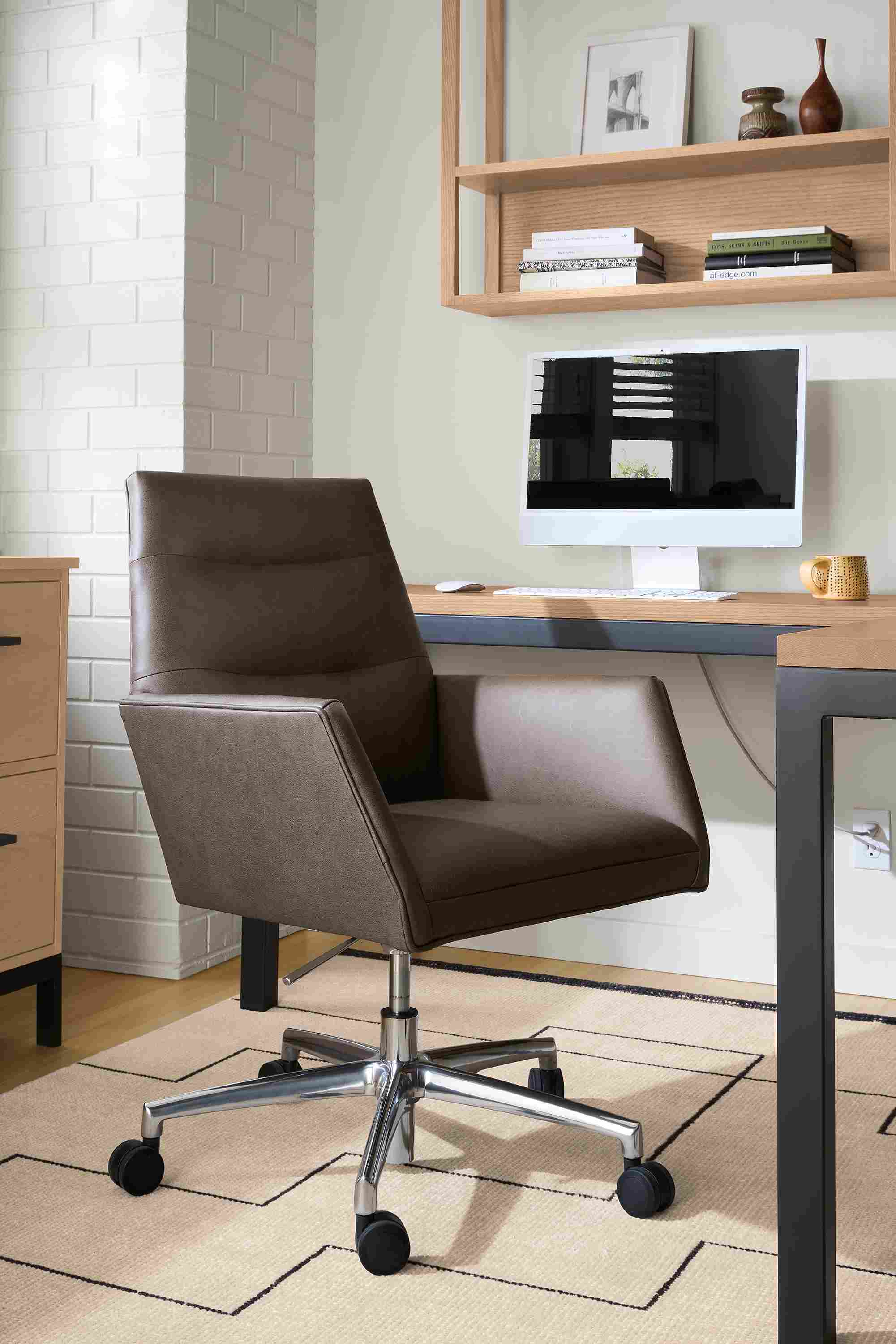 Office with tenley office chair in fiero mink leather and navi 8 by 10 rug in ivory/black.