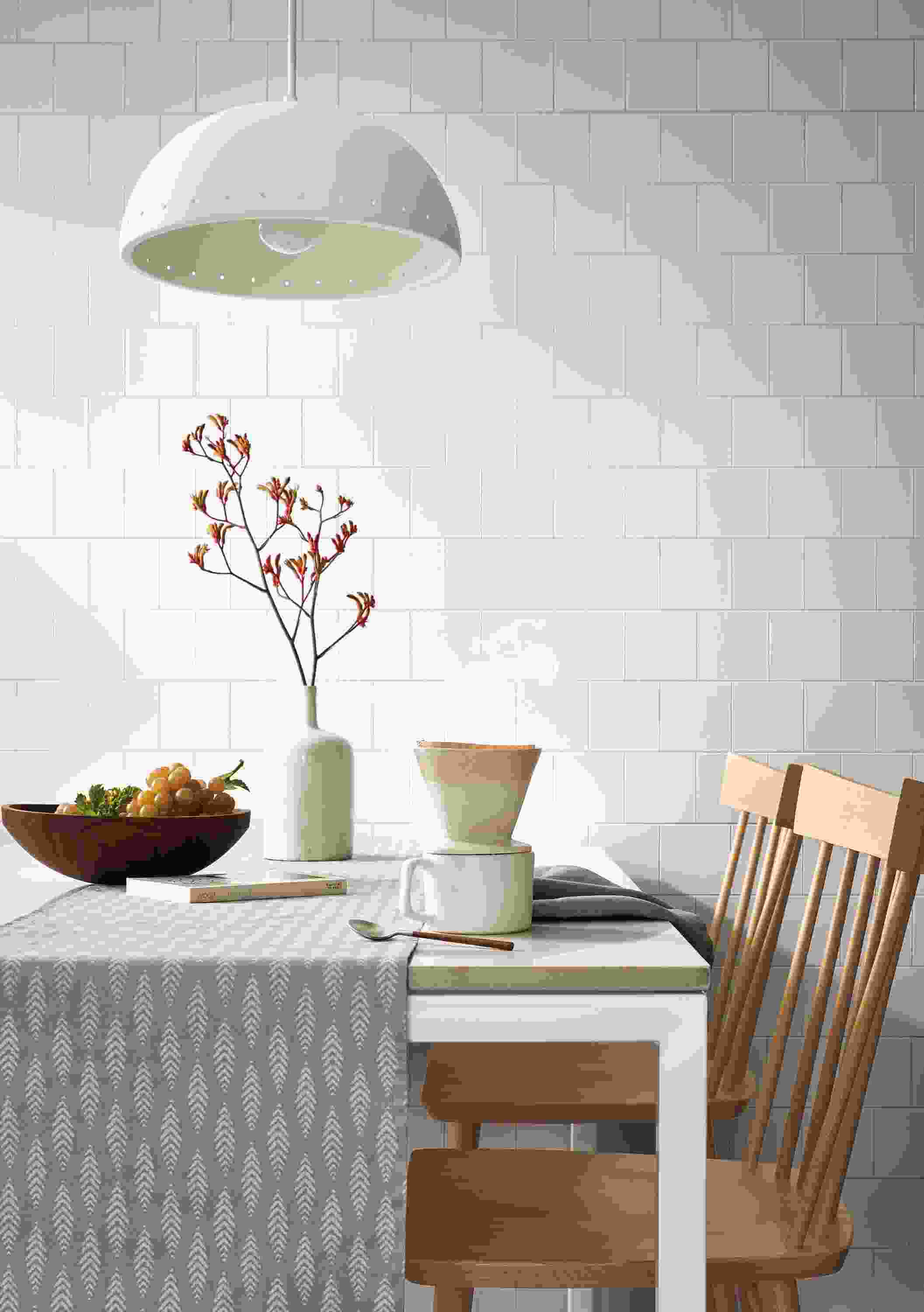 room setting with parsons table, ashwin table runner, Thatcher chairs, coffee cup, malin pendant.