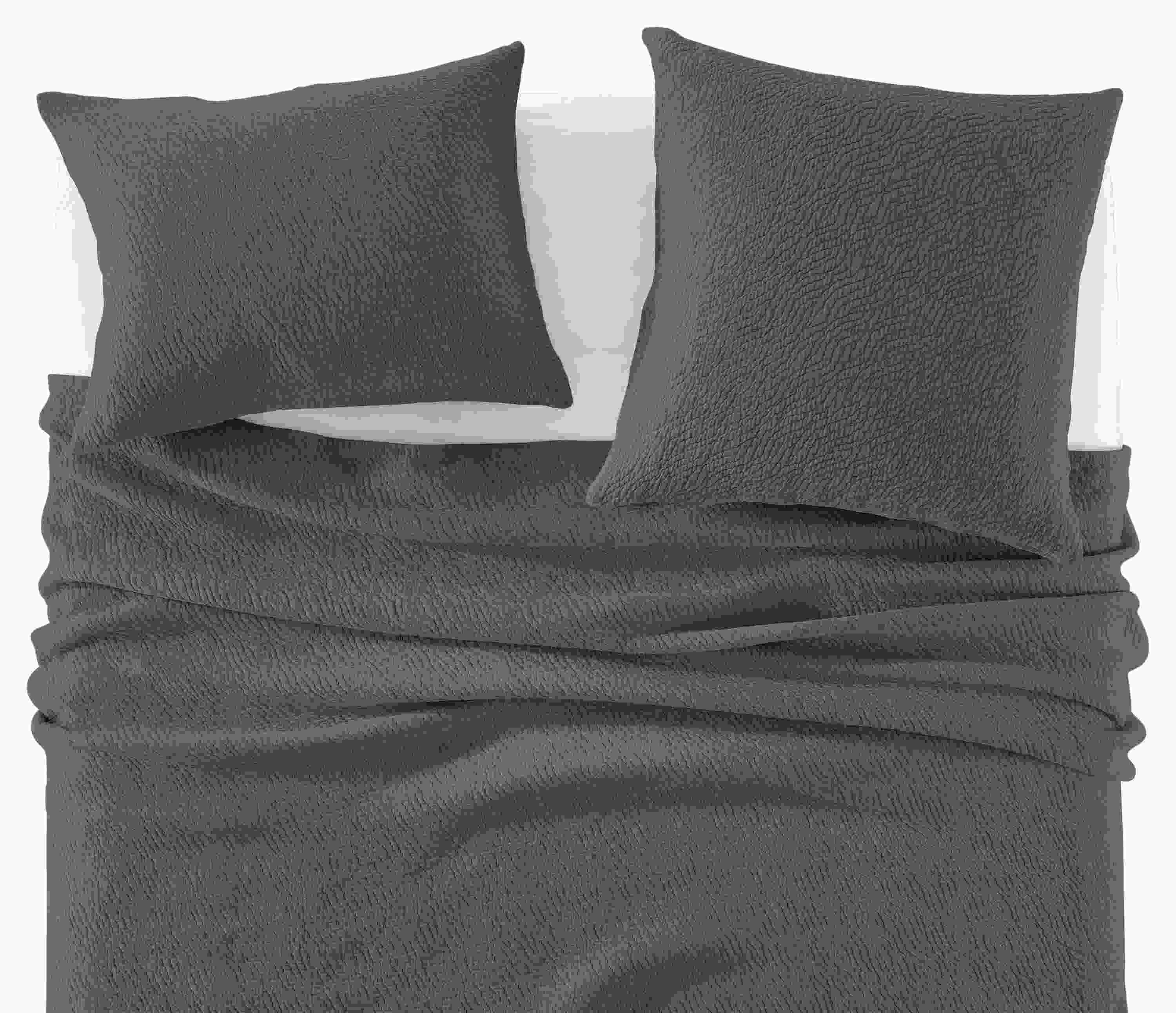 Detail of Thea Matelasse Full-Queen Coverlet and shams in Spruce with White percale sheets.