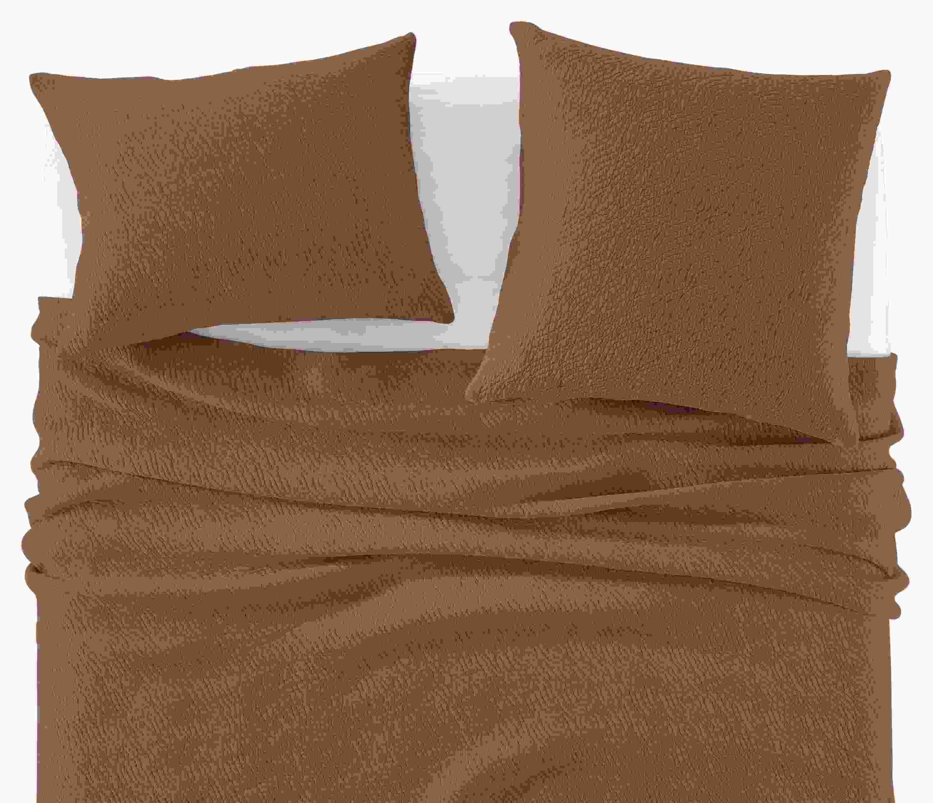 Detail of Thea Matelasse Full-Queen Coverlet and shams in Brick with White percale sheets.