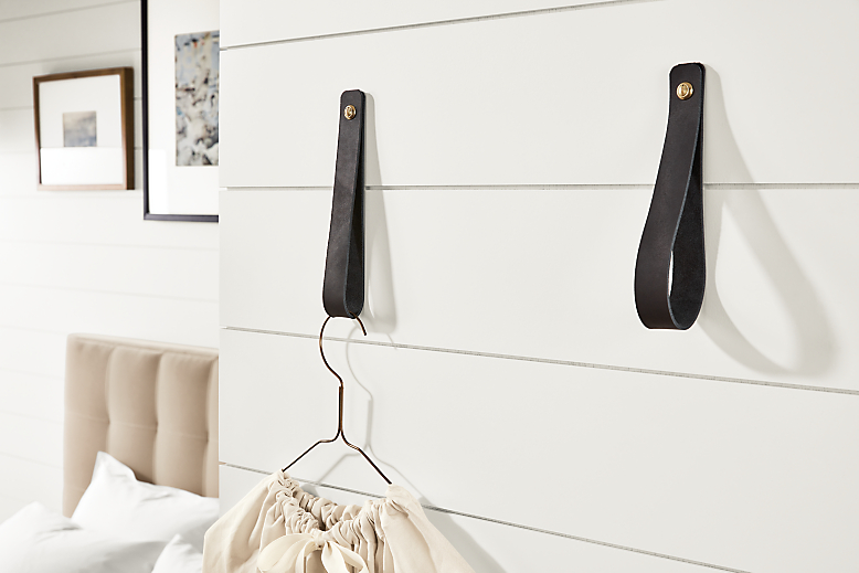 Detail of two Thorton leather wall hooks in black leather.