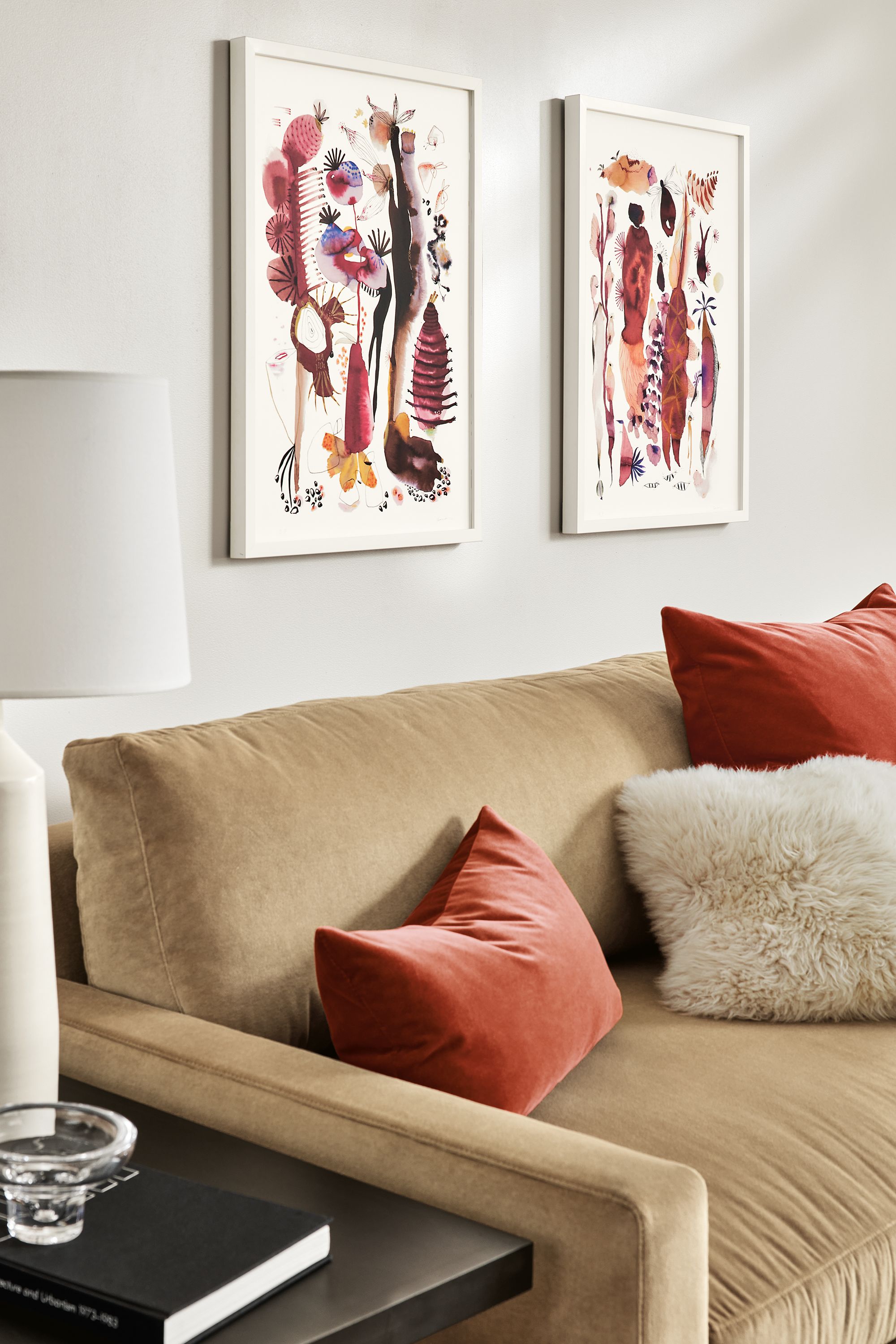 detail of two suyao tian prints above sofa in living room.