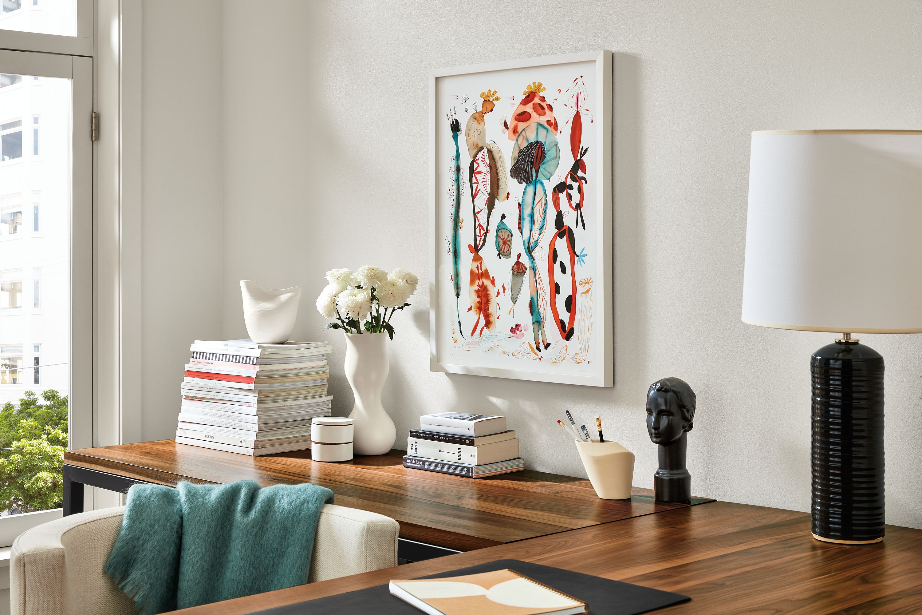 detail of suyao tian print in office above walnut desk.