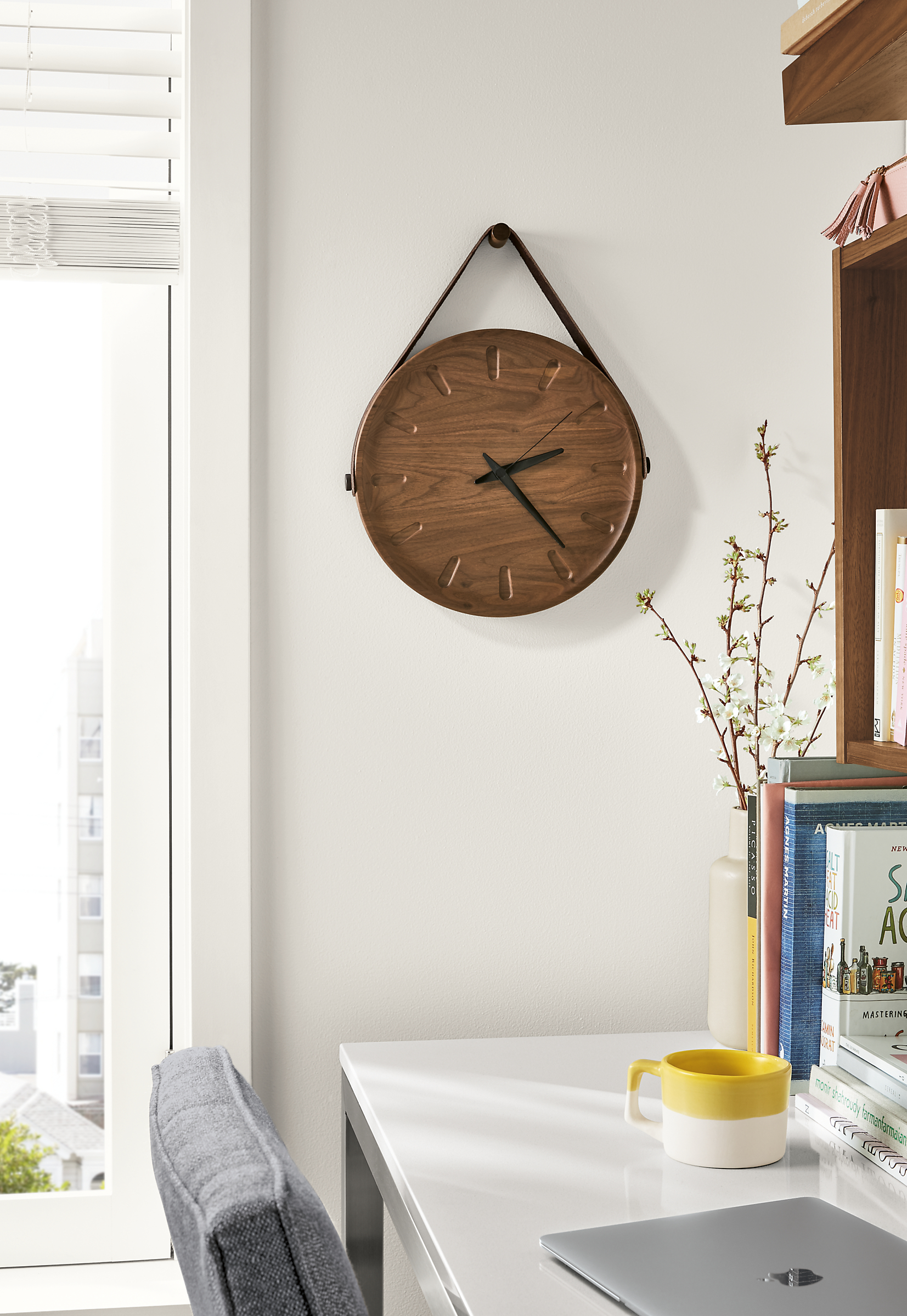 Detail of Toland wall clock in walnut above desk.