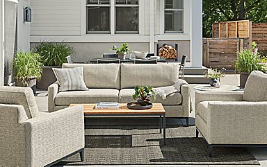 Tomas outdoor sofa and two chairs in Phipps taupe fabric with Parsons 48-wide coffee table in graphite with Bamboo top.